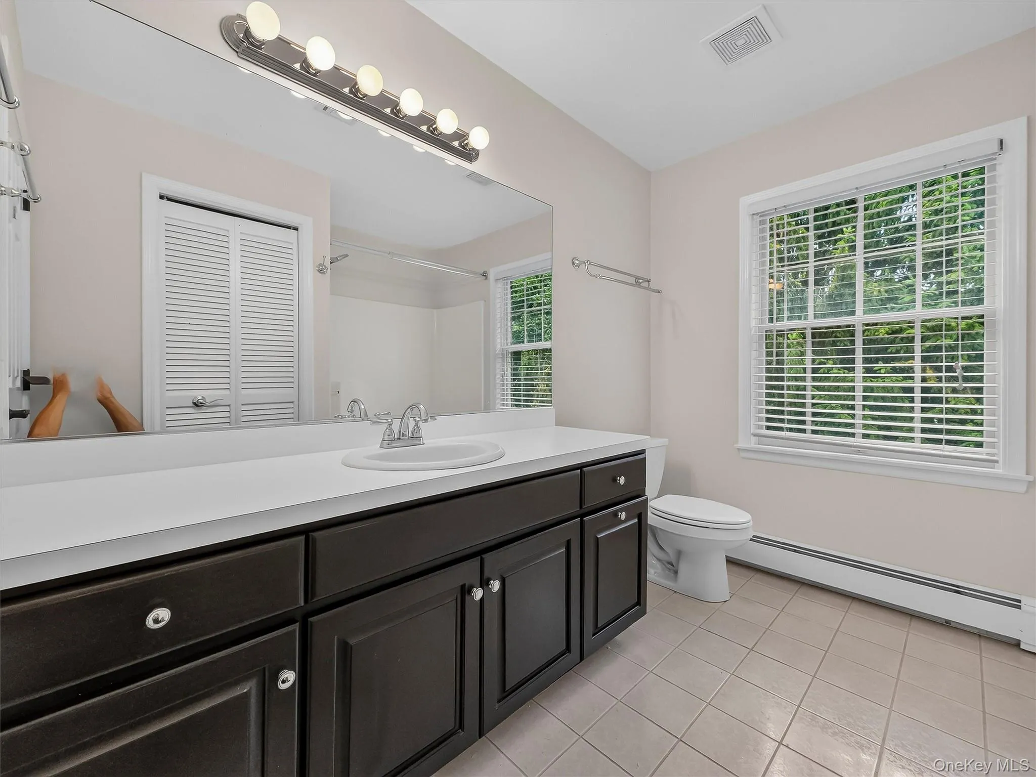 The spacious upstairs bath features a large vanity, abundant natural light and plenty of room for busy morning routines. The spacious upstairs bath features a large vanity, abundant natural light and plenty of room for busy morning routines.