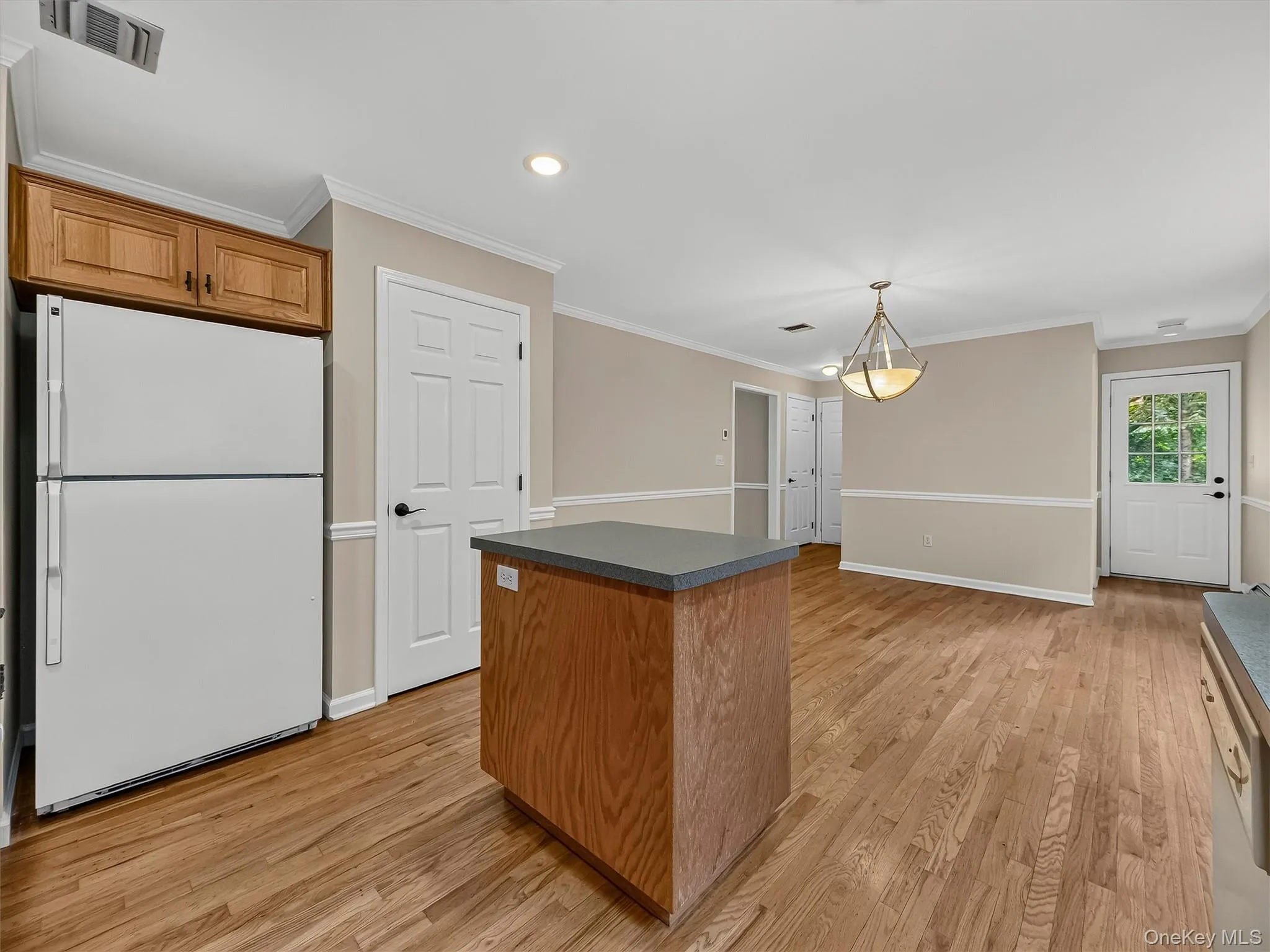 A convenient pantry provides additional storage, while the open layout creates an easy connection between the kitchen and spacious dining area. A convenient pantry provides additional storage, while the open layout creates an easy connection between the kitchen and spacious dining area.