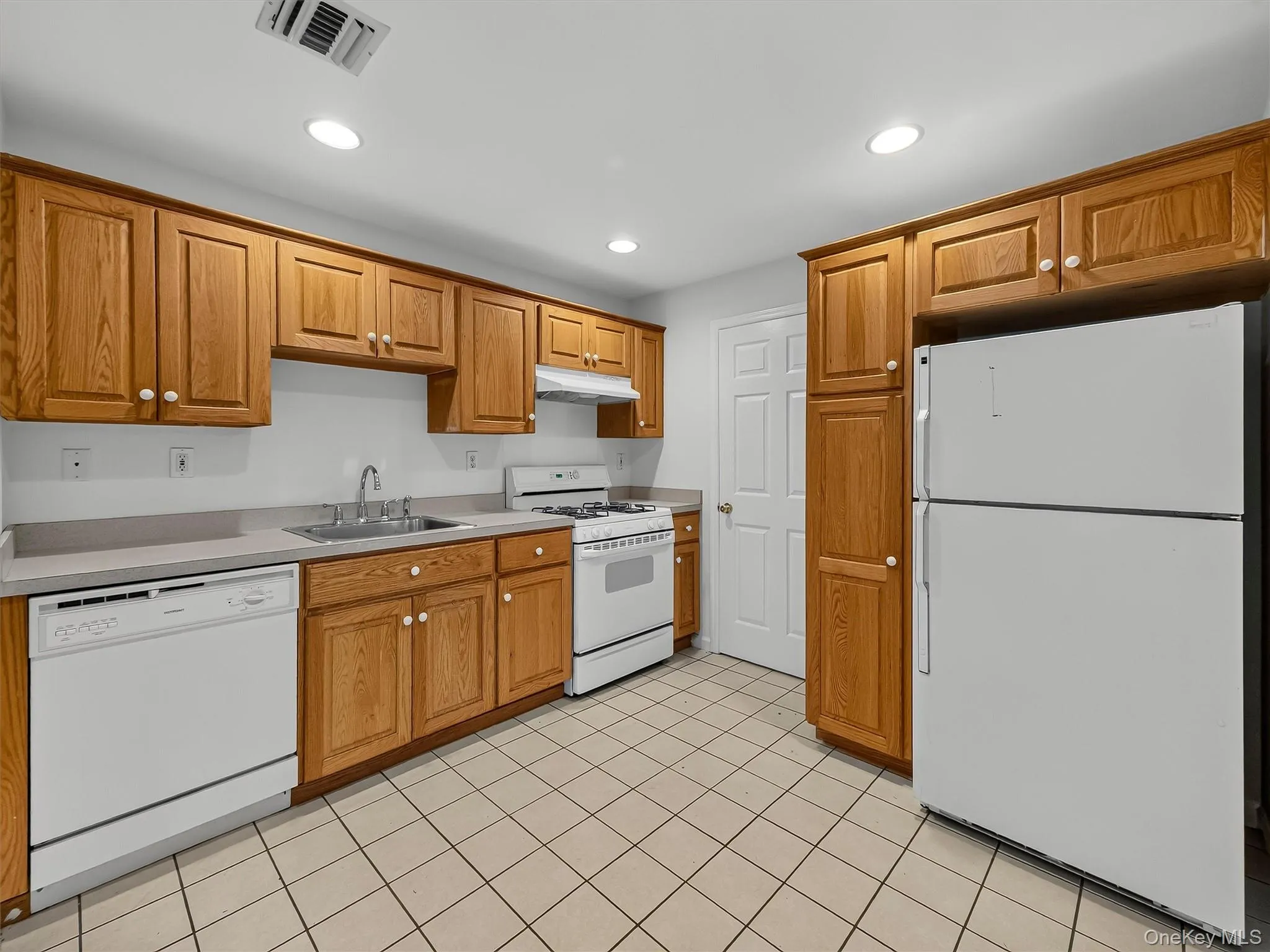 Generous cabinetry, full-size appliances and additional storage offered in the lower-level summer kitchen Generous cabinetry, full-size appliances and additional storage offered in the lower-level summer kitchen