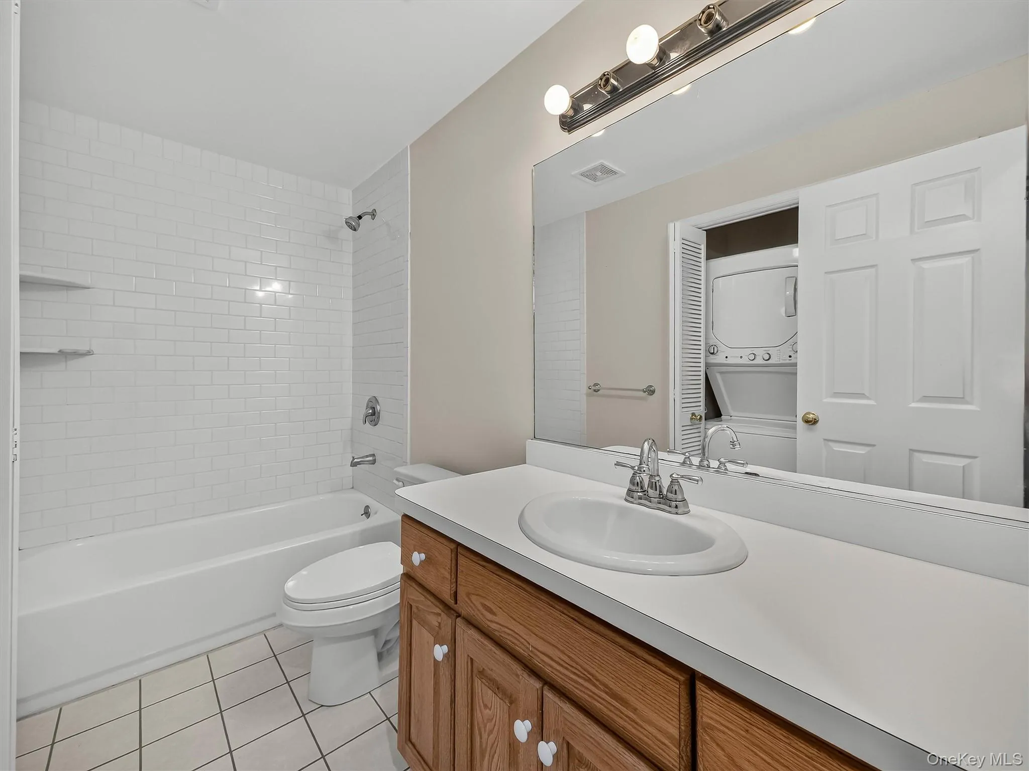 A full bath with second laundry area adds to the convenience of the lower level, with a stackable washer and dryer dedicated to this level of the home. A full bath with second laundry area adds to the convenience of the lower level, with a stackable washer and dryer dedicated to this level of the home.