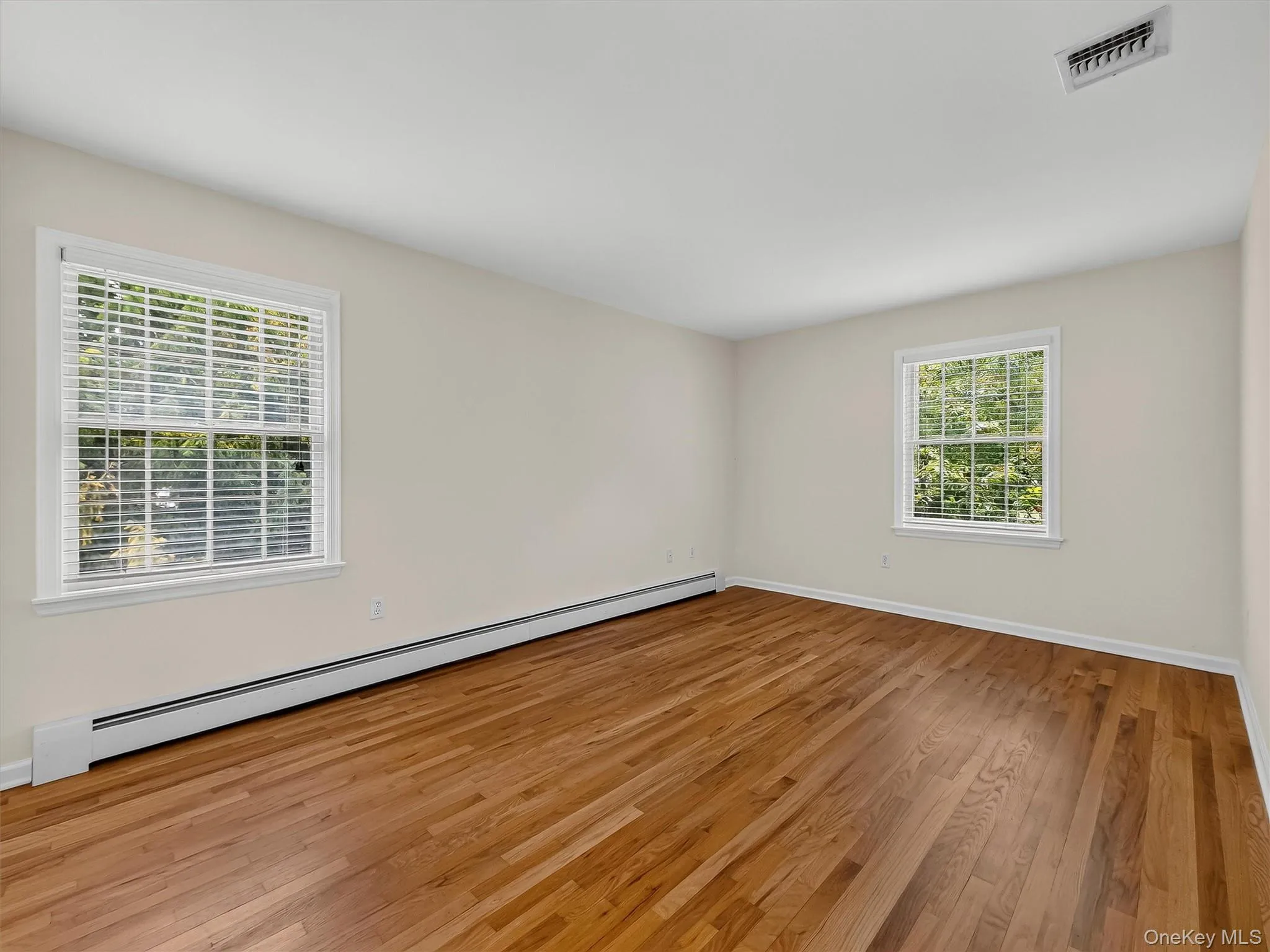 Generous proportions continue in the third bedroom, with hardwood floors and natural light from two exposures creating a bright, comfortable retreat. Generous proportions continue in the third bedroom, with hardwood floors and natural light from two exposures creating a bright, comfortable retreat.