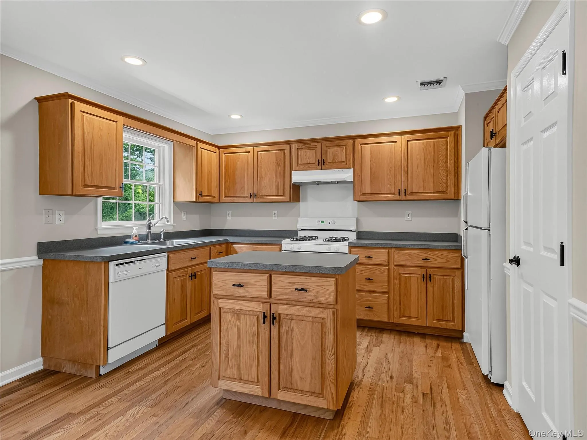 The thoughtfully designed kitchen offers abundant cabinetry, generous prep space, a center island, and a functional layout that makes everyday cooking and entertaining effortless. The thoughtfully designed kitchen offers abundant cabinetry, generous prep space, a center island, and a functional layout that makes everyday cooking and entertaining effortless.