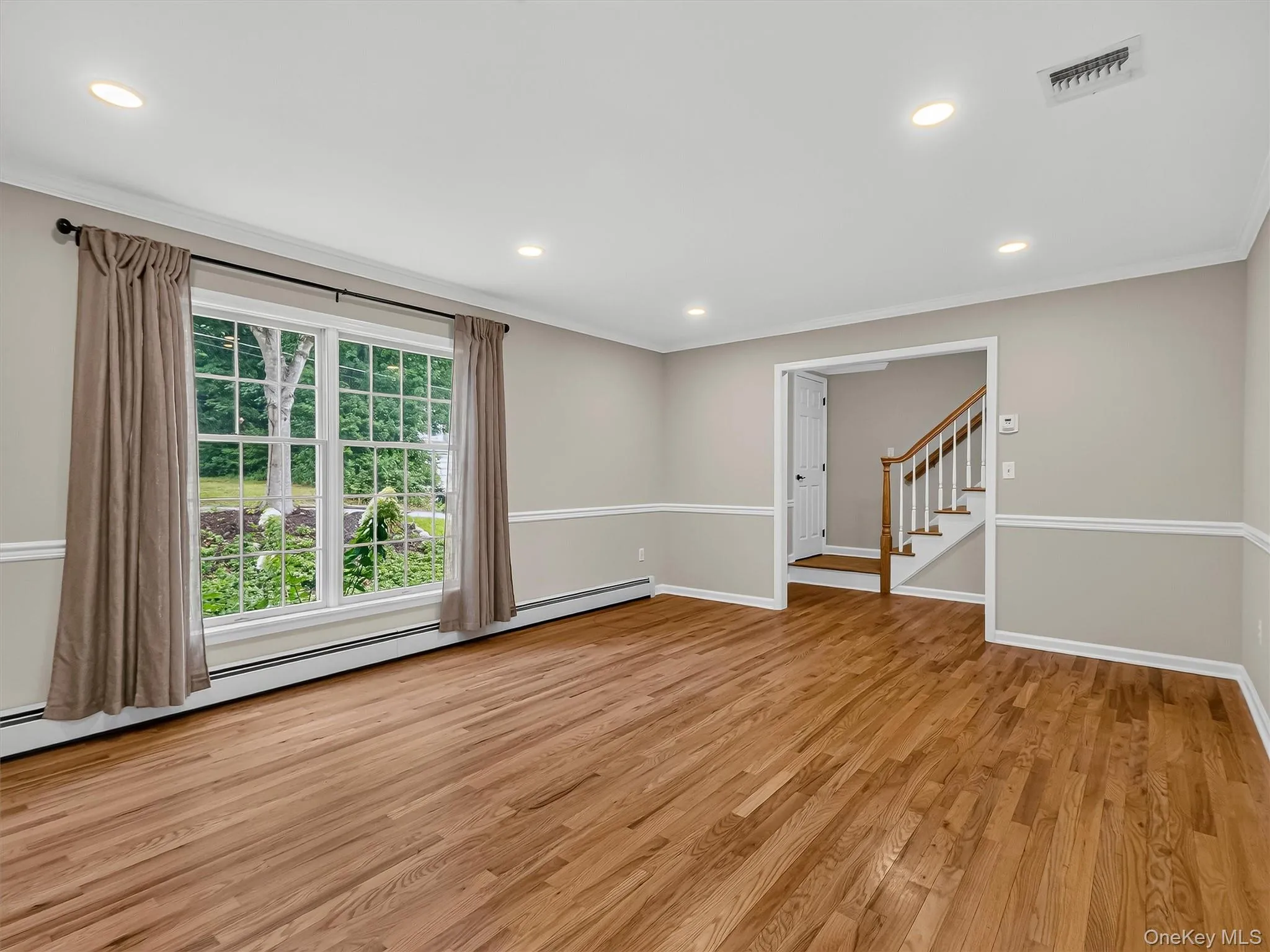 Oversized windows and an open layout fill the living space with natural light, creating an inviting setting for both everyday living and entertaining. Oversized windows and an open layout fill the living space with natural light, creating an inviting setting for both everyday living and entertaining.