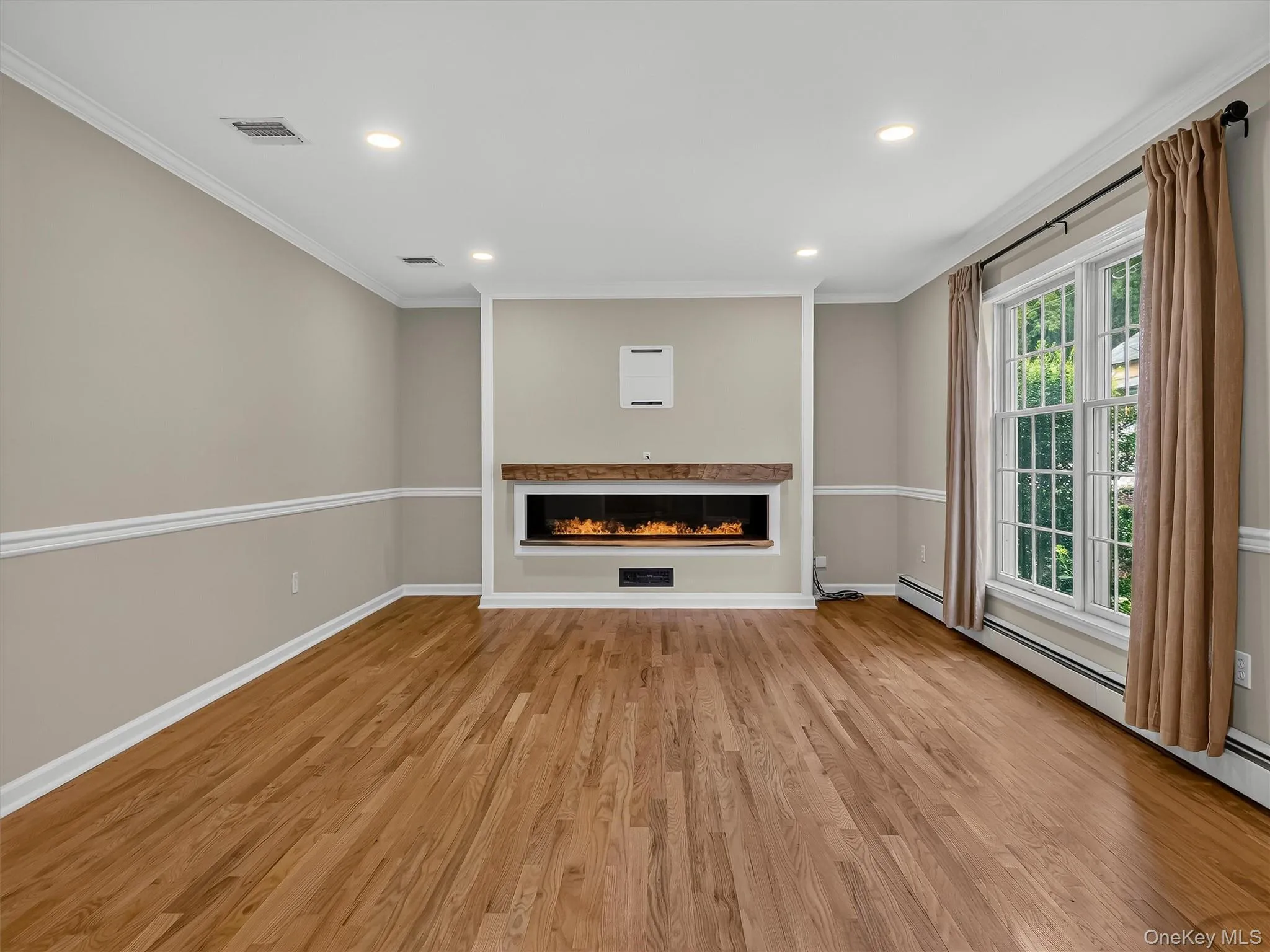 Designed for both comfort and style, the expansive living area features elegant architectural details, recessed lighting, and a striking custom centerpiece. Designed for both comfort and style, the expansive living area features elegant architectural details, recessed lighting, and a striking custom centerpiece.