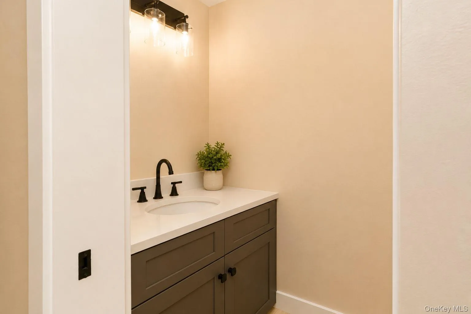 Vanity with a white countertop and an undermount sink 1/2 bath vanity door Vanity with a white countertop and an undermount sink 1/2 bath vanity door