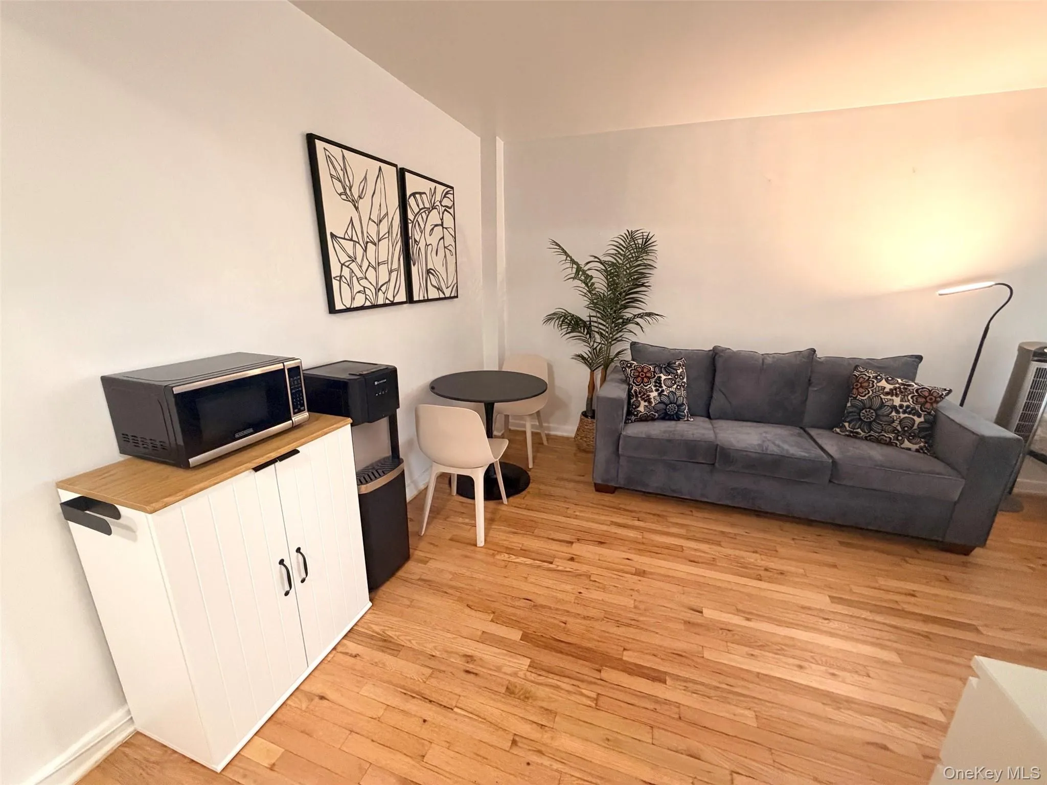 Hardwood-style flooring throughout a spacious living area Hardwood-style flooring throughout a spacious living area