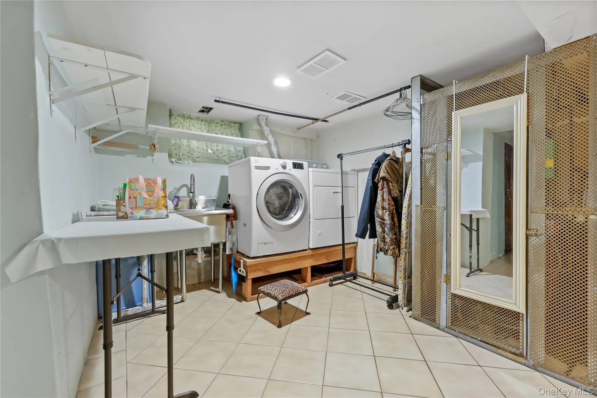 Laundry room with light tile patterned floors and recessed lighting Laundry room with light tile patterned floors and recessed lighting