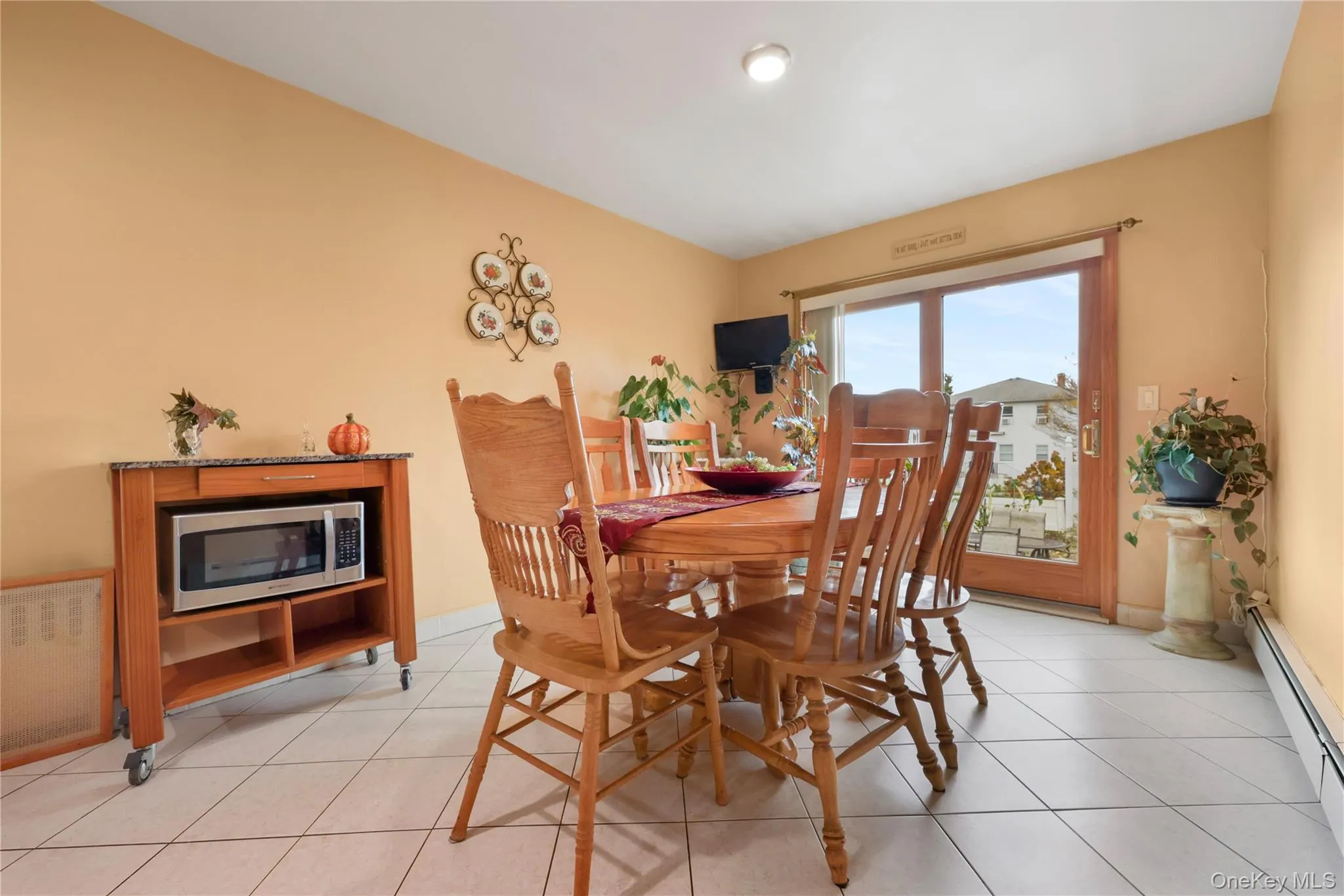 Dining room featuring baseboard heating and light tile patterned floors Dining room featuring baseboard heating and light tile patterned floors