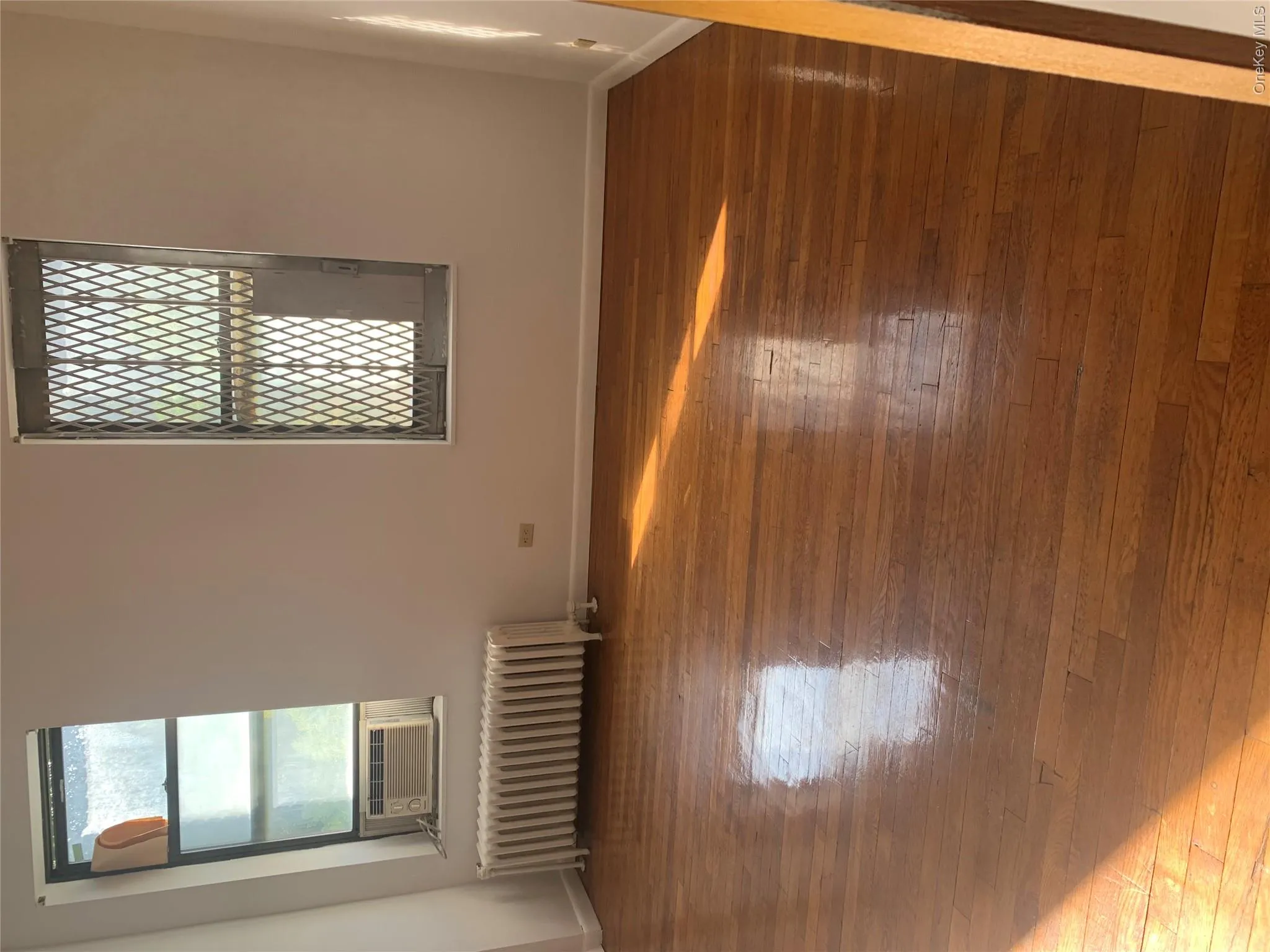 Hardwood flooring throughout the room, complemented by white walls and trim Hardwood flooring throughout the room, complemented by white walls and trim