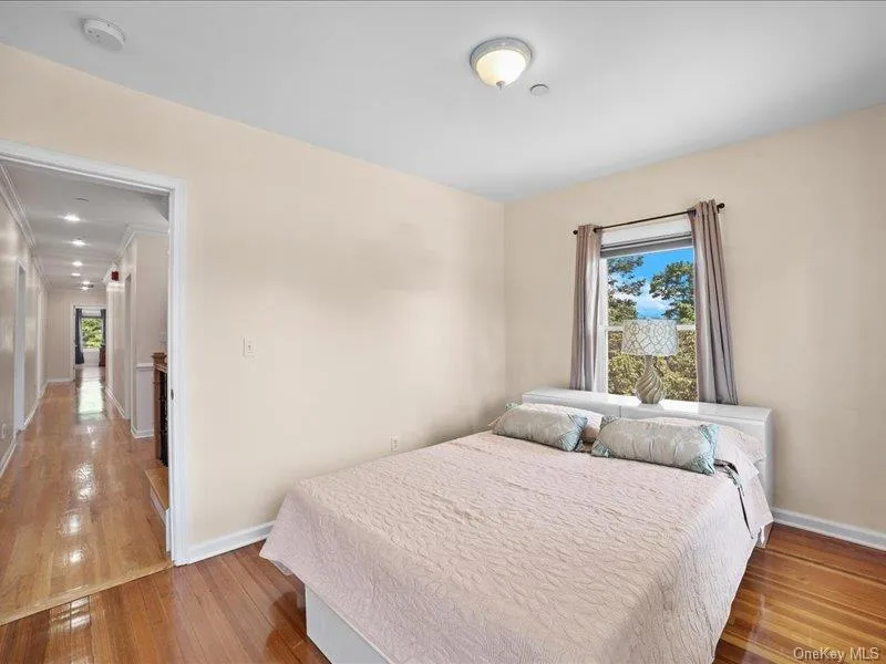 Bedroom featuring baseboards and hardwood / wood-style flooring Bedroom featuring baseboards and hardwood / wood-style flooring