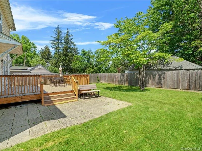 View of yard with a wooden deck and a patio View of yard with a wooden deck and a patio