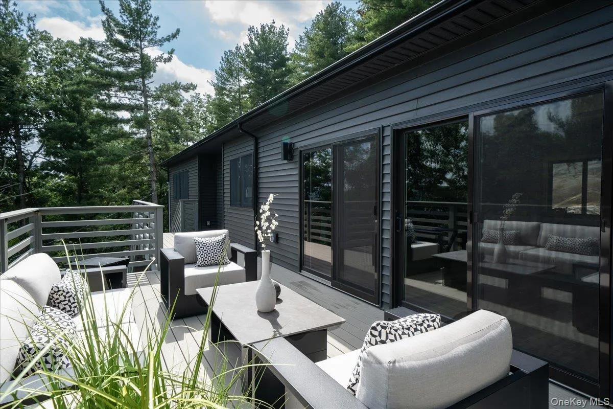 Exterior composite deck with wood-finish railing and sliding doors Exterior composite deck with wood-finish railing and sliding doors