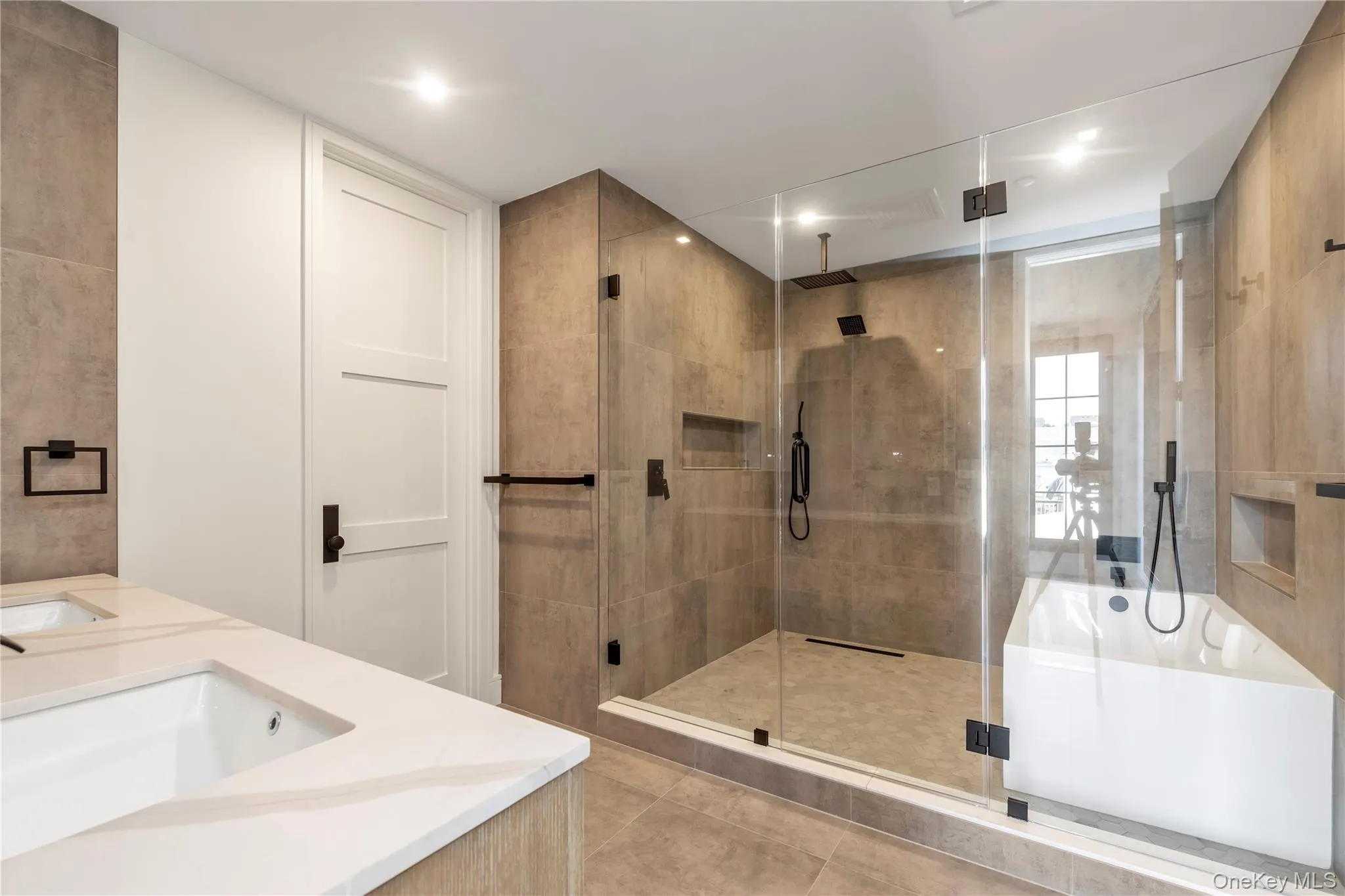 Bathroom featuring a stall shower, a garden tub, tile patterned flooring, double vanity, and recessed lighting Bathroom featuring a stall shower, a garden tub, tile patterned flooring, double vanity, and recessed lighting