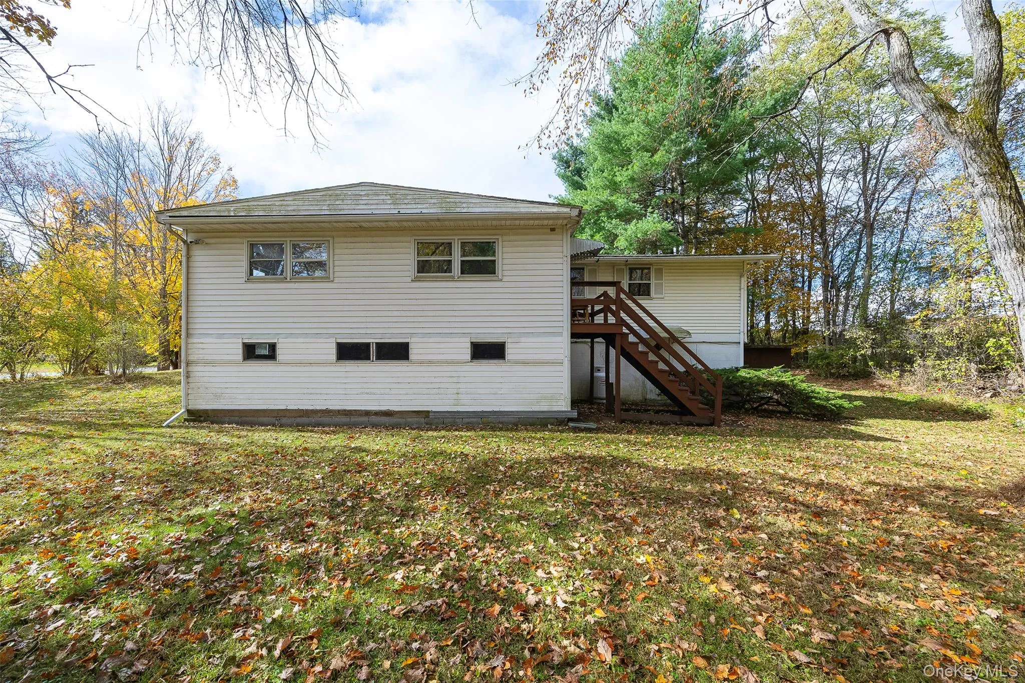 Rear view of property featuring stairs and a yard Rear view of property featuring stairs and a yard