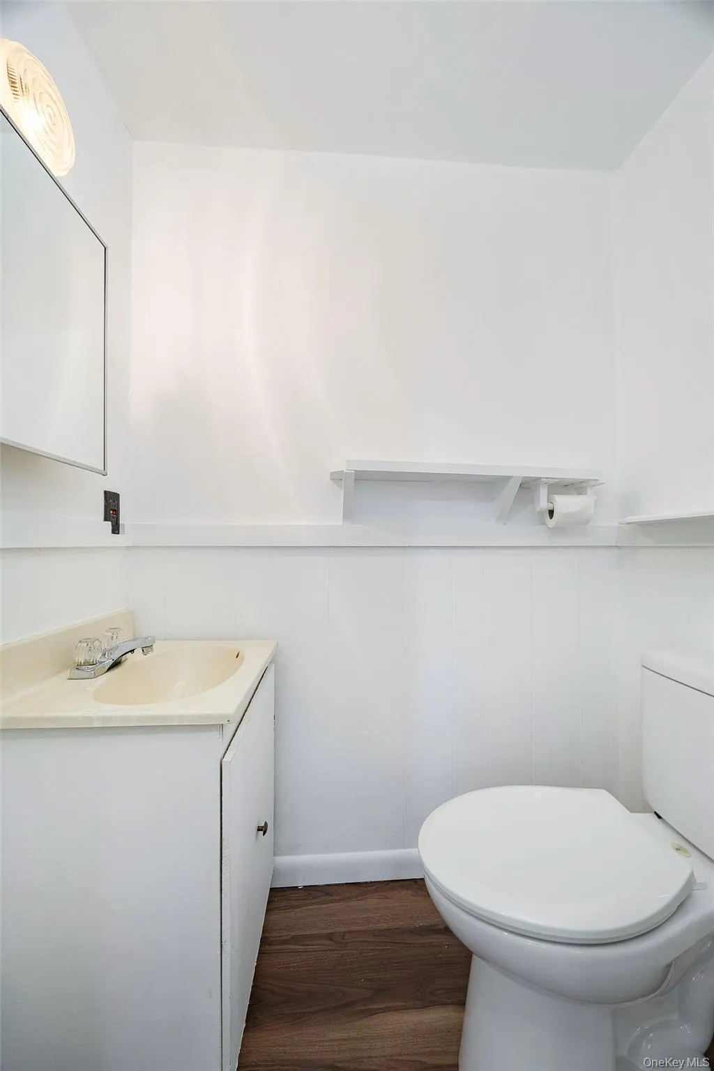 Half bath featuring dark wood-style flooring and vanity Half bath featuring dark wood-style flooring and vanity