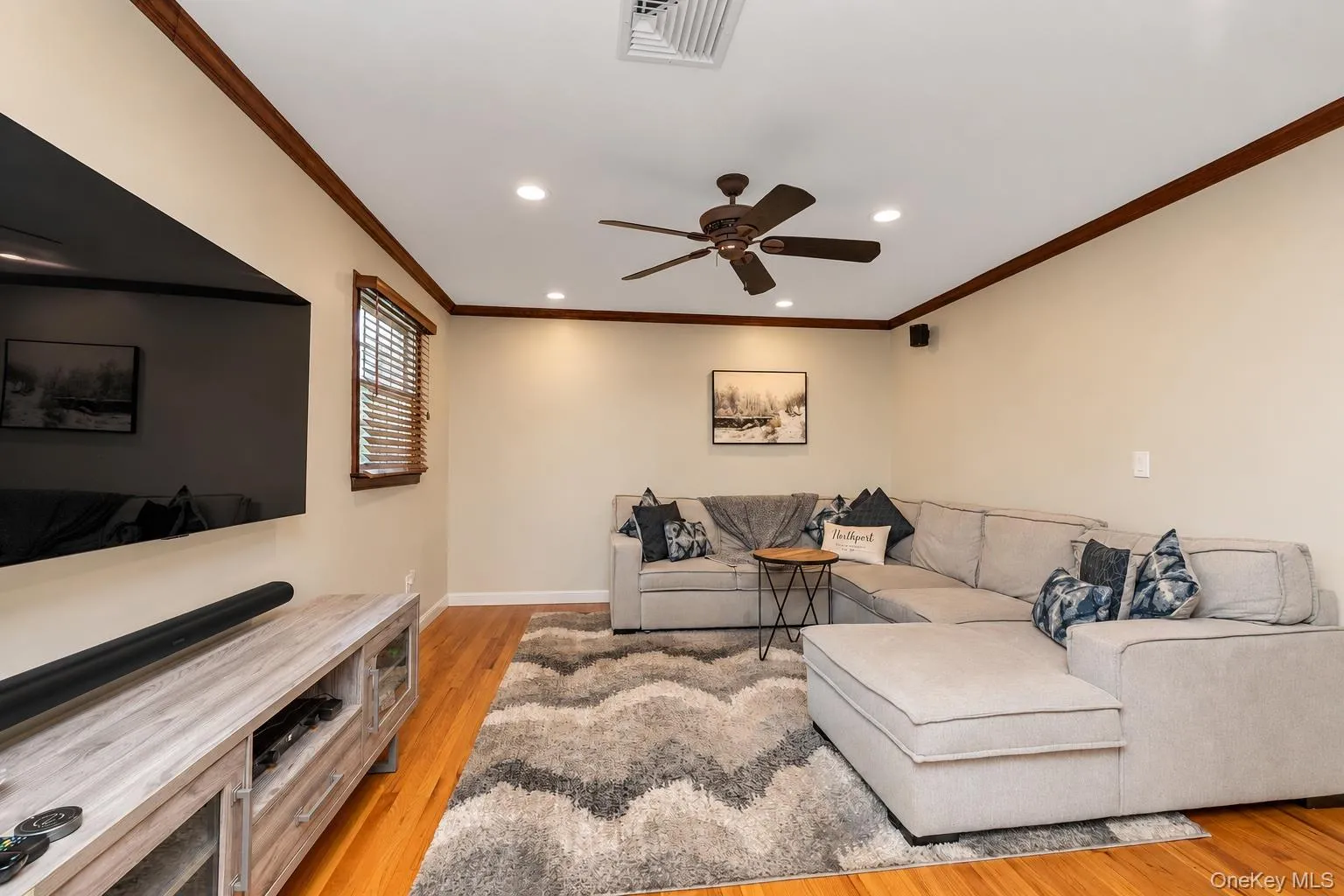 Over sized family room with crown molding and hardwood floors. Over sized family room with crown molding and hardwood floors.