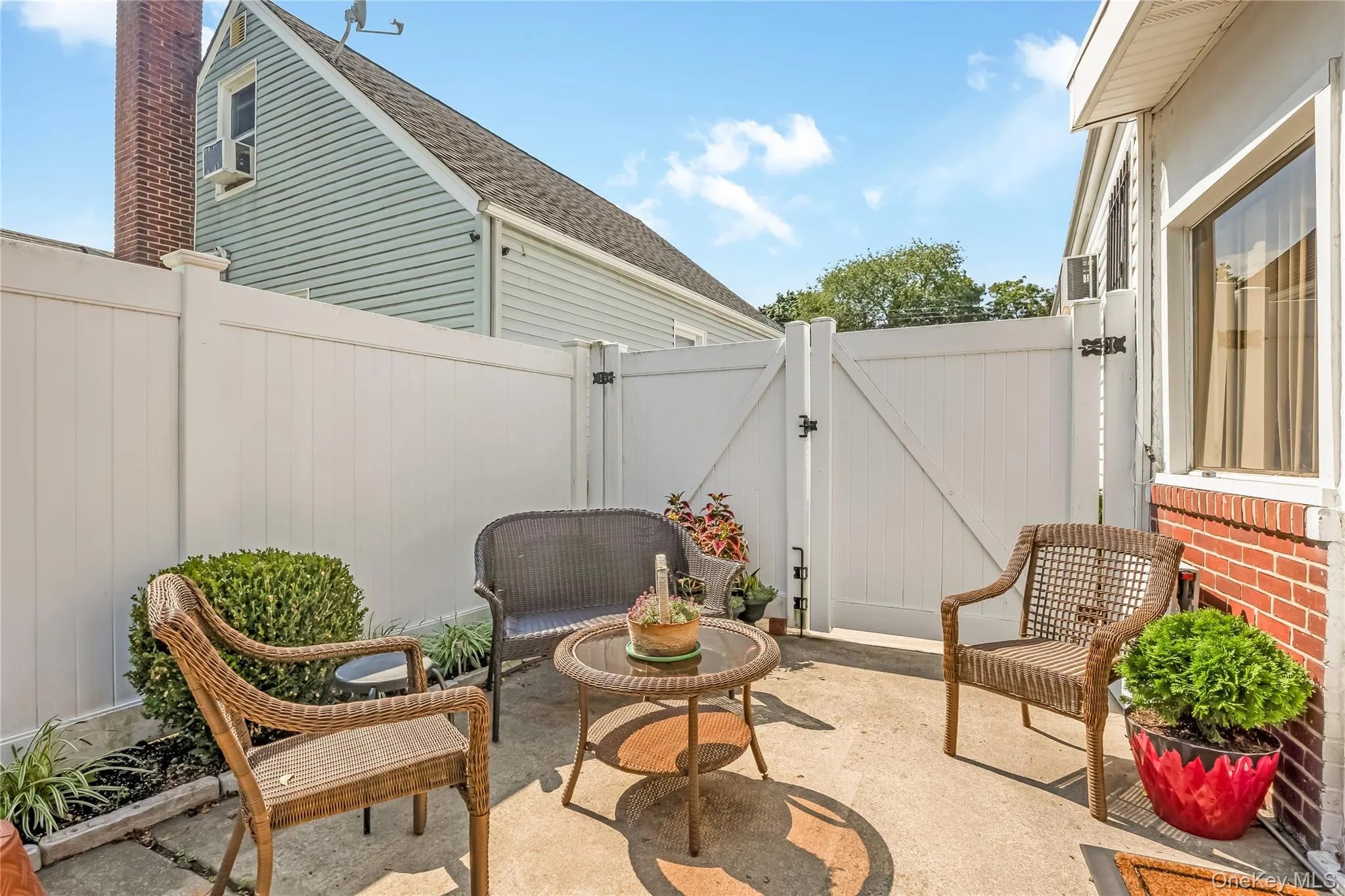 OUTDOOR SITTING AREA BEHIND DOUBLE GATES AT THE PAVED DRIVEWAY OUTDOOR SITTING AREA BEHIND DOUBLE GATES AT THE PAVED DRIVEWAY