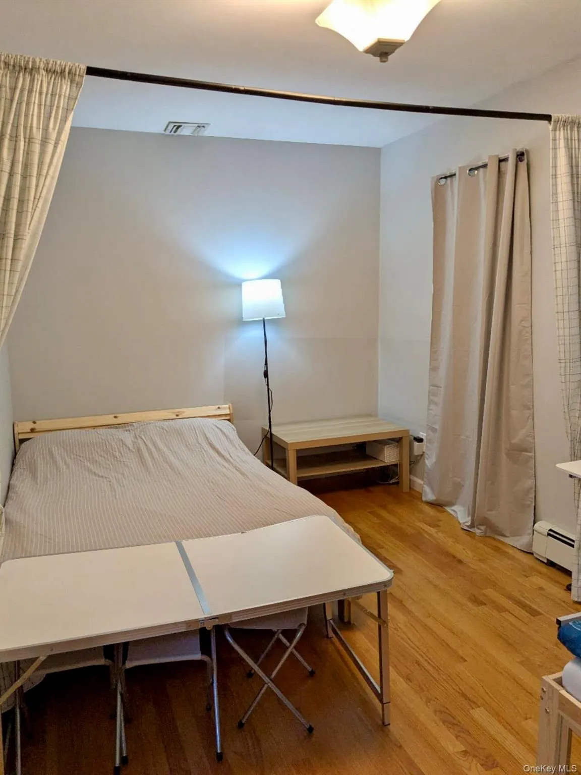 Hardwood-style flooring throughout this room with light-colored walls Hardwood-style flooring throughout this room with light-colored walls