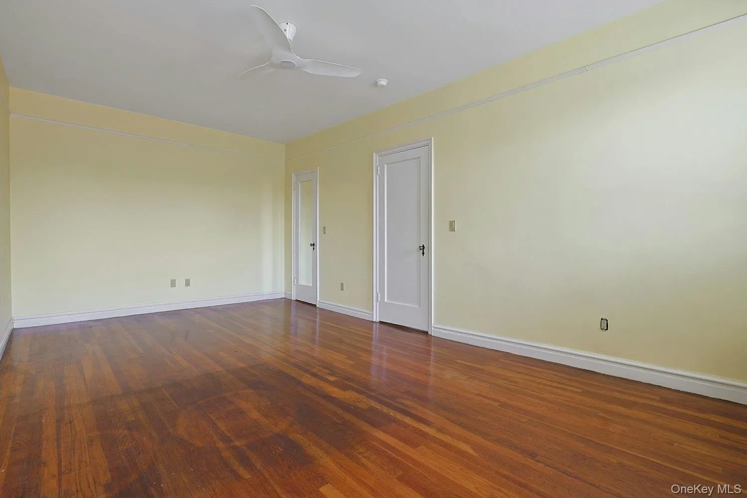Comfortable Primary Bedroom with Hardwood Floors and Ample Wall Space Comfortable Primary Bedroom with Hardwood Floors and Ample Wall Space