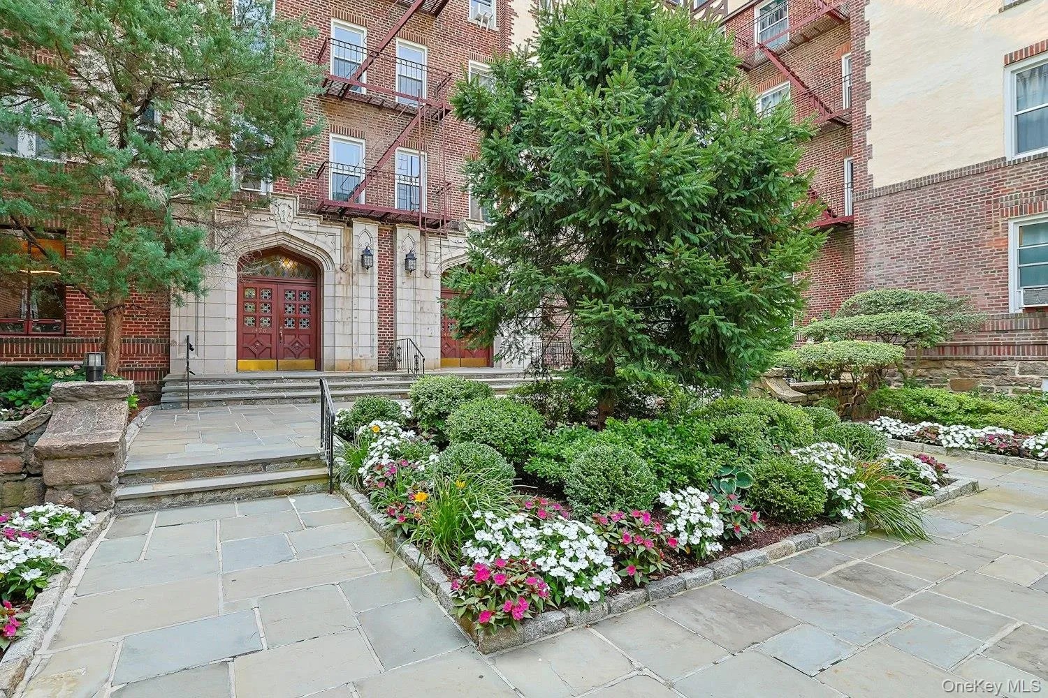 Charming Building Entrance Framed by Mature Landscaping Charming Building Entrance Framed by Mature Landscaping