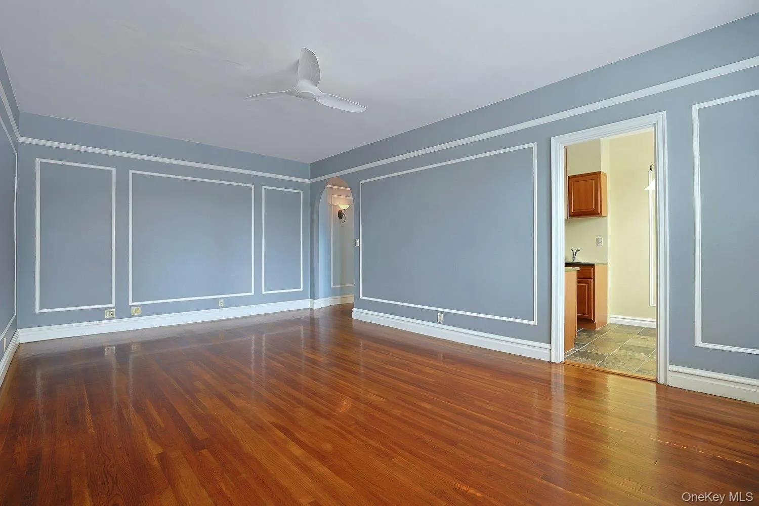 Graceful Living Room with Detailed Wall Molding and Hardwood Flooring Graceful Living Room with Detailed Wall Molding and Hardwood Flooring
