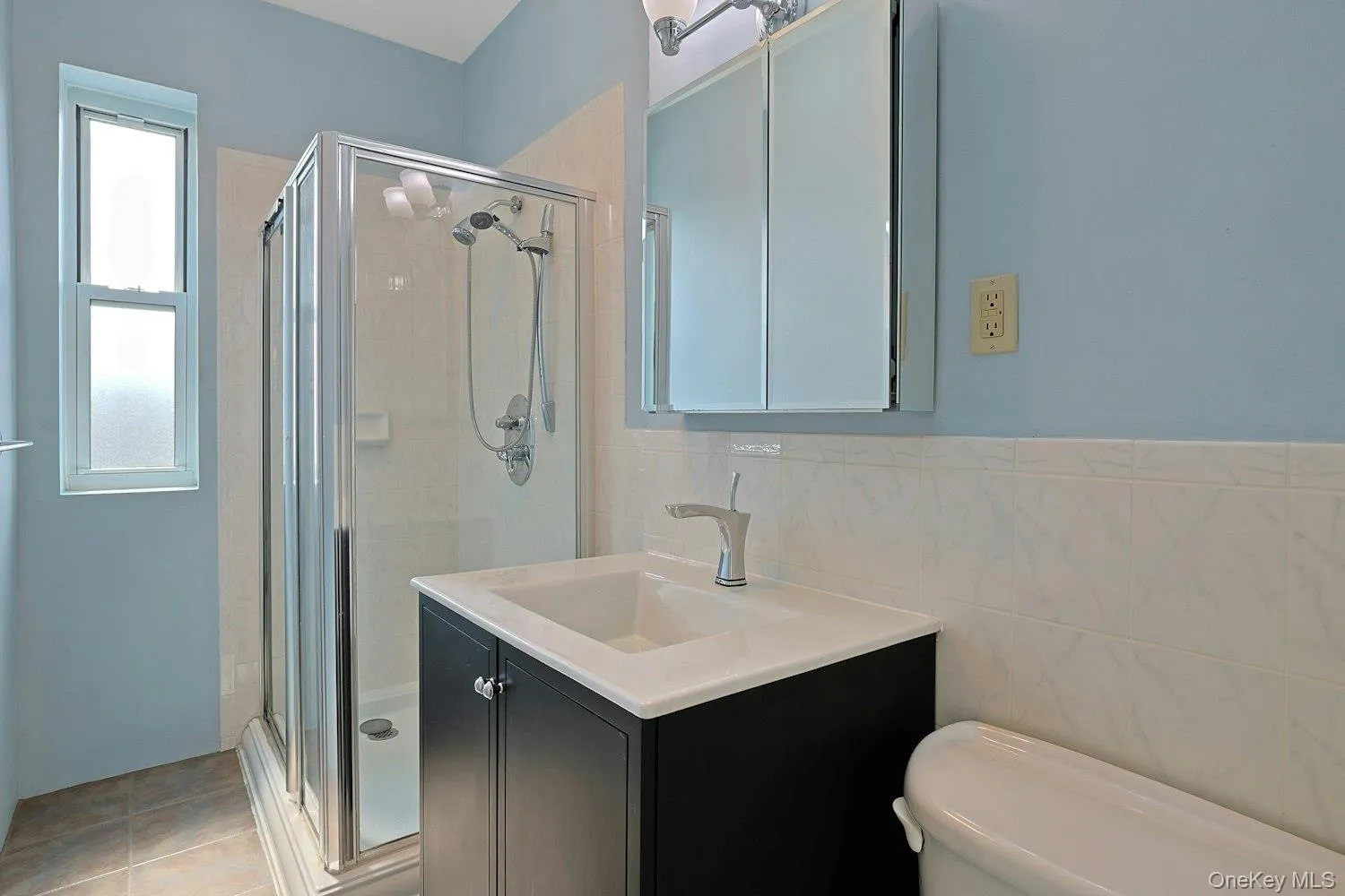 Windowed Full Bath with Glass-Enclosed Shower and Modern Vanity Windowed Full Bath with Glass-Enclosed Shower and Modern Vanity
