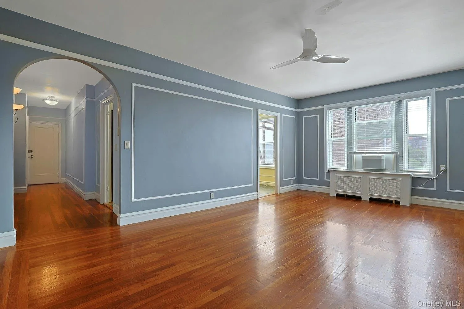Expansive Living Room Showcasing Hardwood Floors and Classic Millwork Expansive Living Room Showcasing Hardwood Floors and Classic Millwork