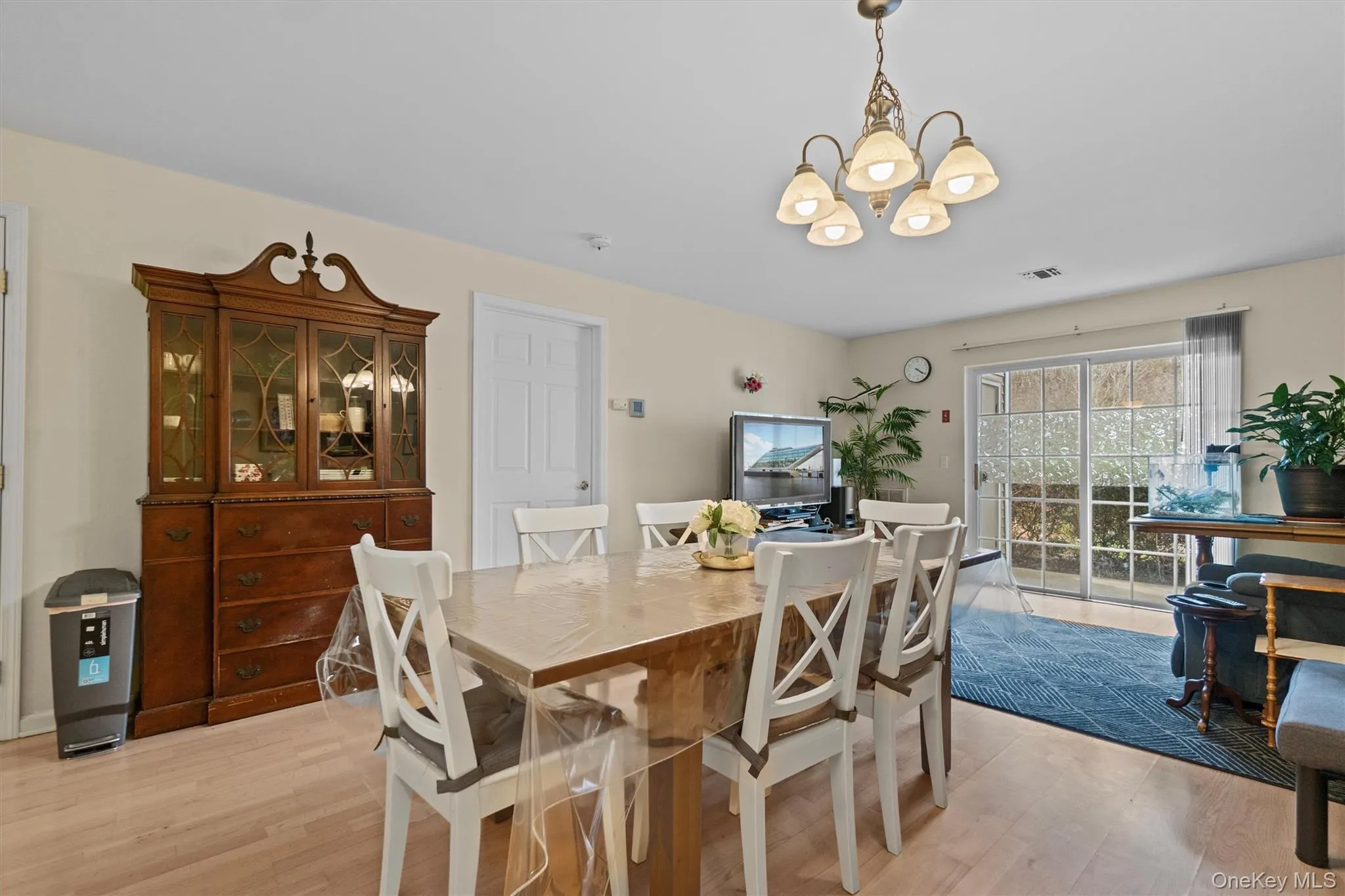 Dining space with light wood-style flooring, a notable chandelier, and visible vents Dining space with light wood-style flooring, a notable chandelier, and visible vents