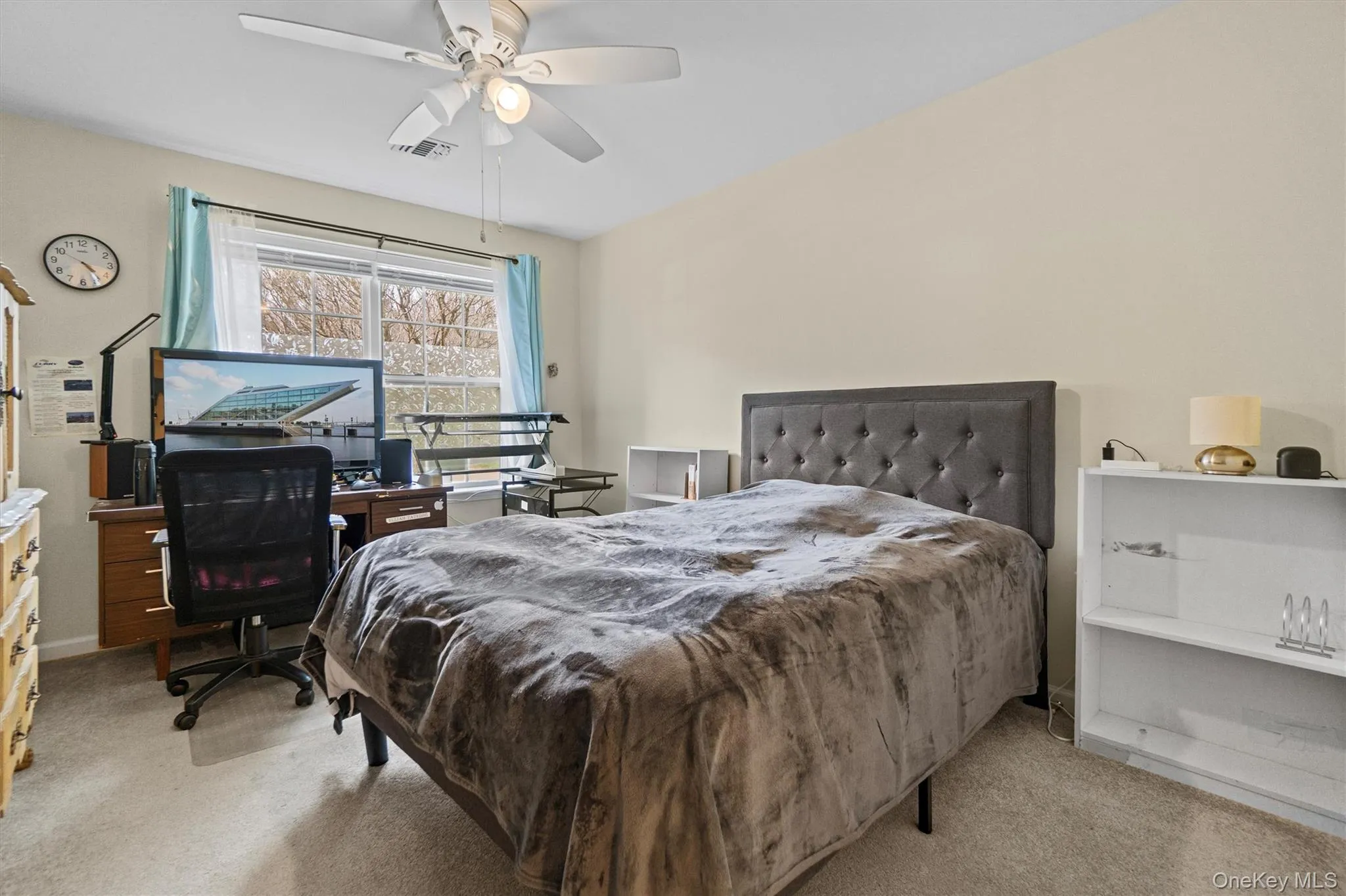 Carpeted bedroom with ceiling fan, baseboards, and visible vents Carpeted bedroom with ceiling fan, baseboards, and visible vents