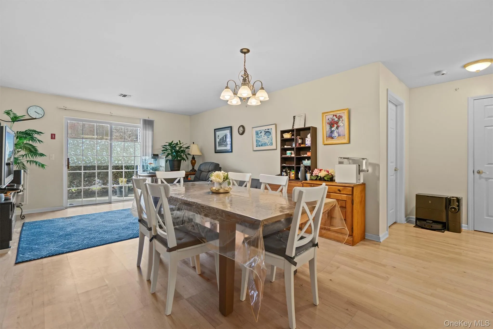 Dining area featuring a chandelier, light wood-type flooring Dining area featuring a chandelier, light wood-type flooring