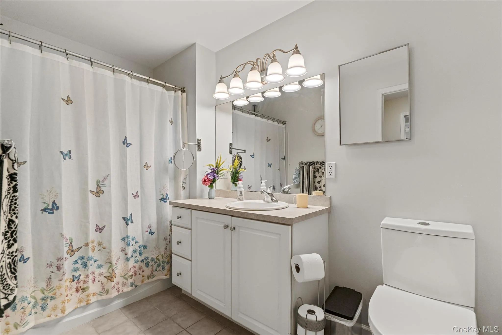 Bathroom featuring toilet, tile patterned flooring, and vanity Bathroom featuring toilet, tile patterned flooring, and vanity