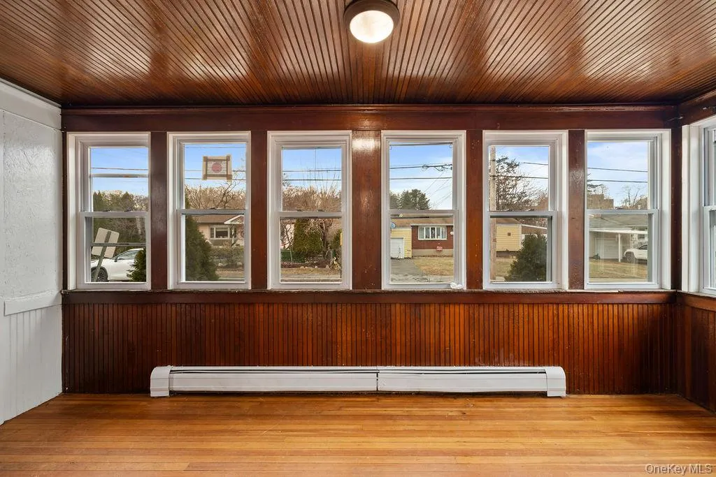 Unfurnished sunroom with baseboard heating Unfurnished sunroom with baseboard heating