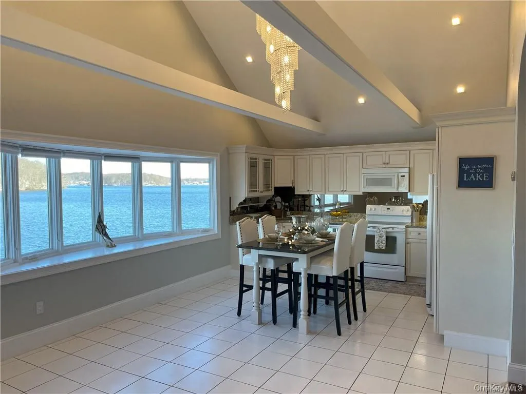 Dining room featuring a water view Dining room featuring a water view