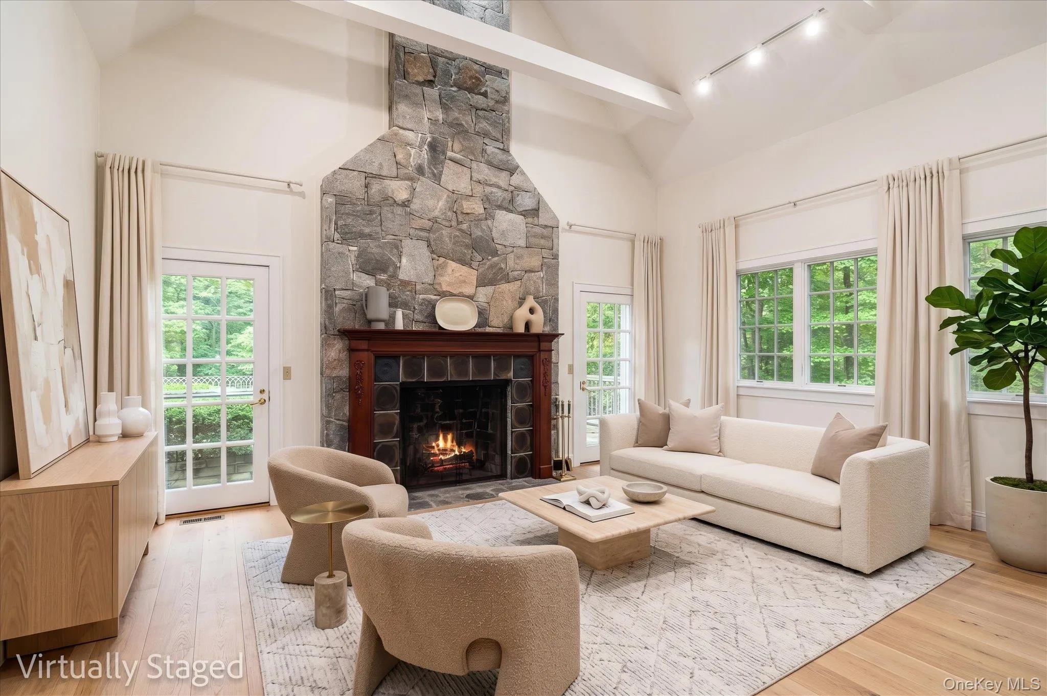 Virtually staged for inspiration. The fireplace anchors the room, flanked by doors to access an additional patio, vaulted ceiling with beams. Virtually staged for inspiration. The fireplace anchors the room, flanked by doors to access an additional patio, vaulted ceiling with beams.