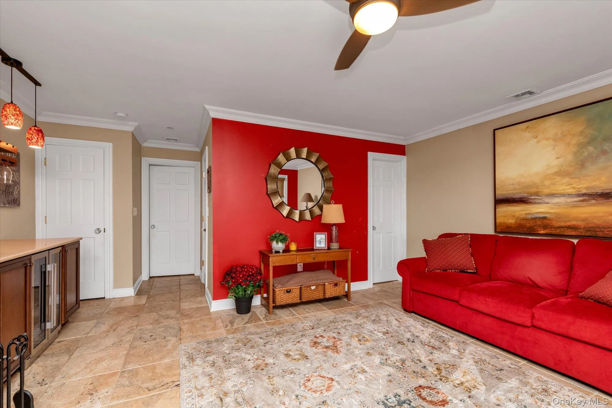 Open living space featuring tile flooring, crown molding, and a built-in beverage refrigerator with quartz counter top-gas fireplace-plenty of closets Open living space featuring tile flooring, crown molding, and a built-in beverage refrigerator with quartz counter top-gas fireplace-plenty of closets