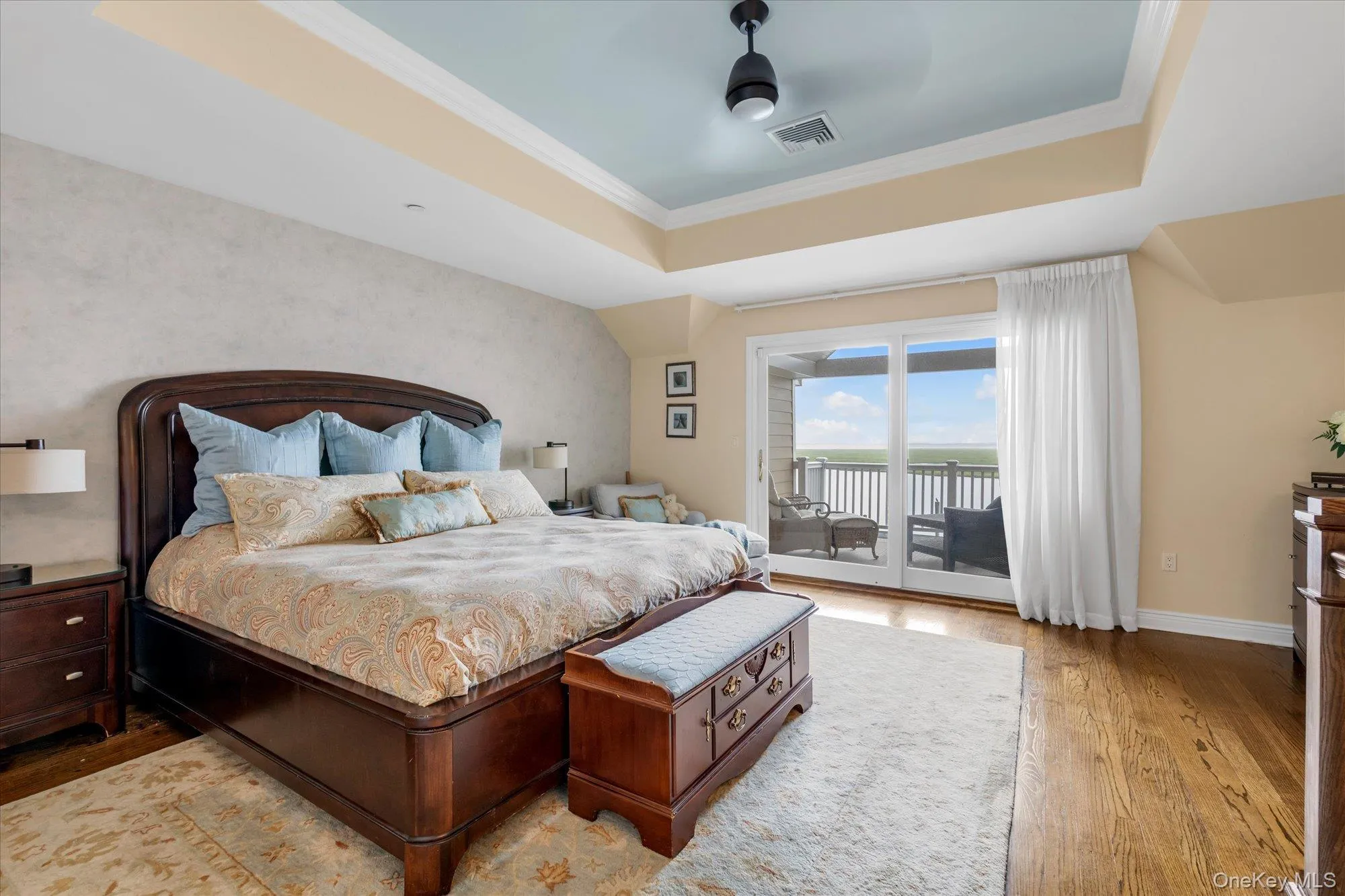 Hardwood flooring throughout, tray ceiling, sliding glass doors to outdoor private deck- ceiling fan, textured accent wall Hardwood flooring throughout, tray ceiling, sliding glass doors to outdoor private deck- ceiling fan, textured accent wall