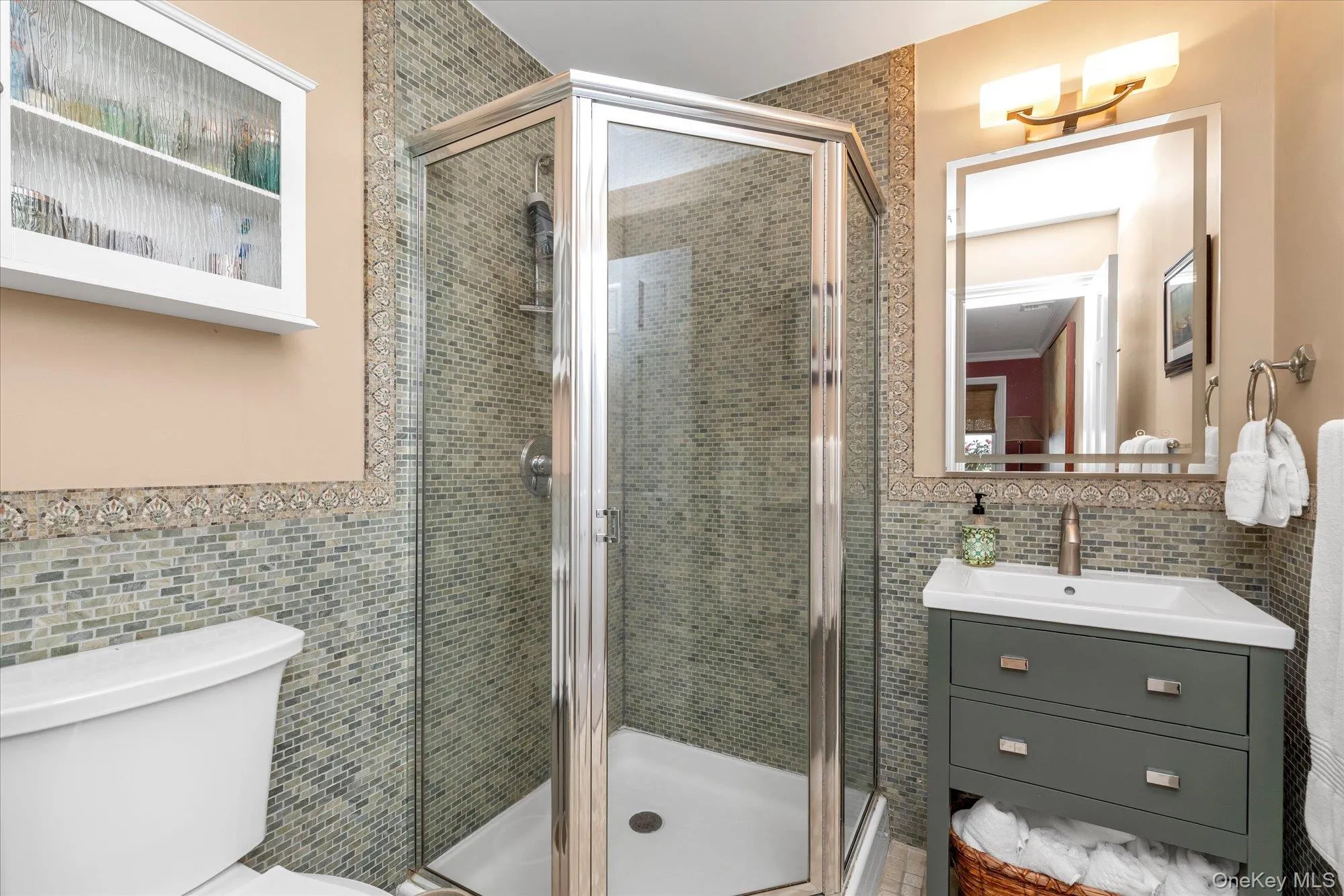 First floor full bath Shower with glass enclosure and mosaic tile surround First floor full bath Shower with glass enclosure and mosaic tile surround