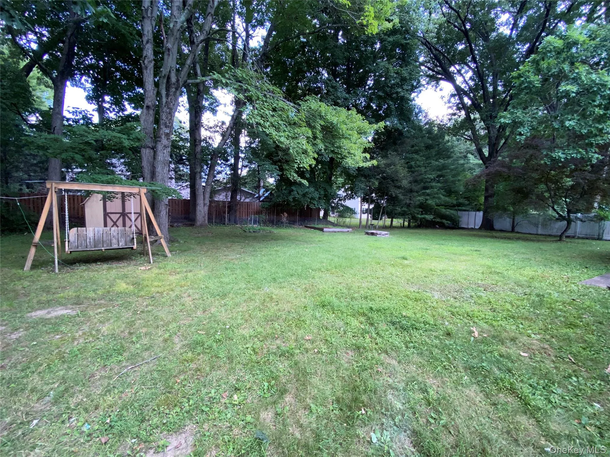Spacious wide open private flat backyard with wooden swing and room for a pool or possibly even a pickleball court Spacious wide open private flat backyard with wooden swing and room for a pool or possibly even a pickleball court