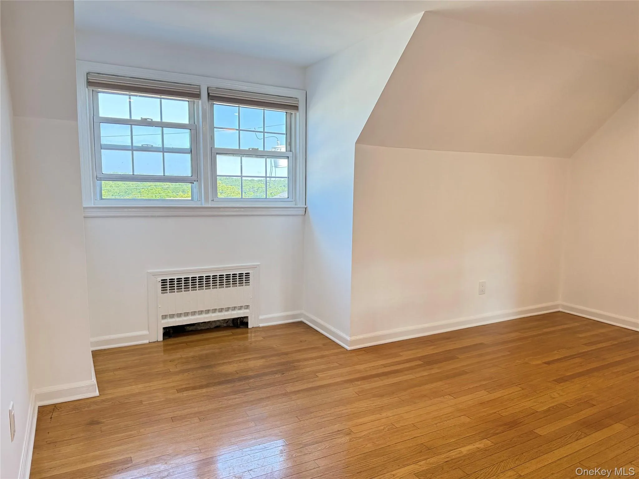 Cozy living room featuring beautiful wood floors, sun filled windows, and a comfortable layout that creates a warm and inviting atmosphere. Cozy living room featuring beautiful wood floors, sun filled windows, and a comfortable layout that creates a warm and inviting atmosphere.