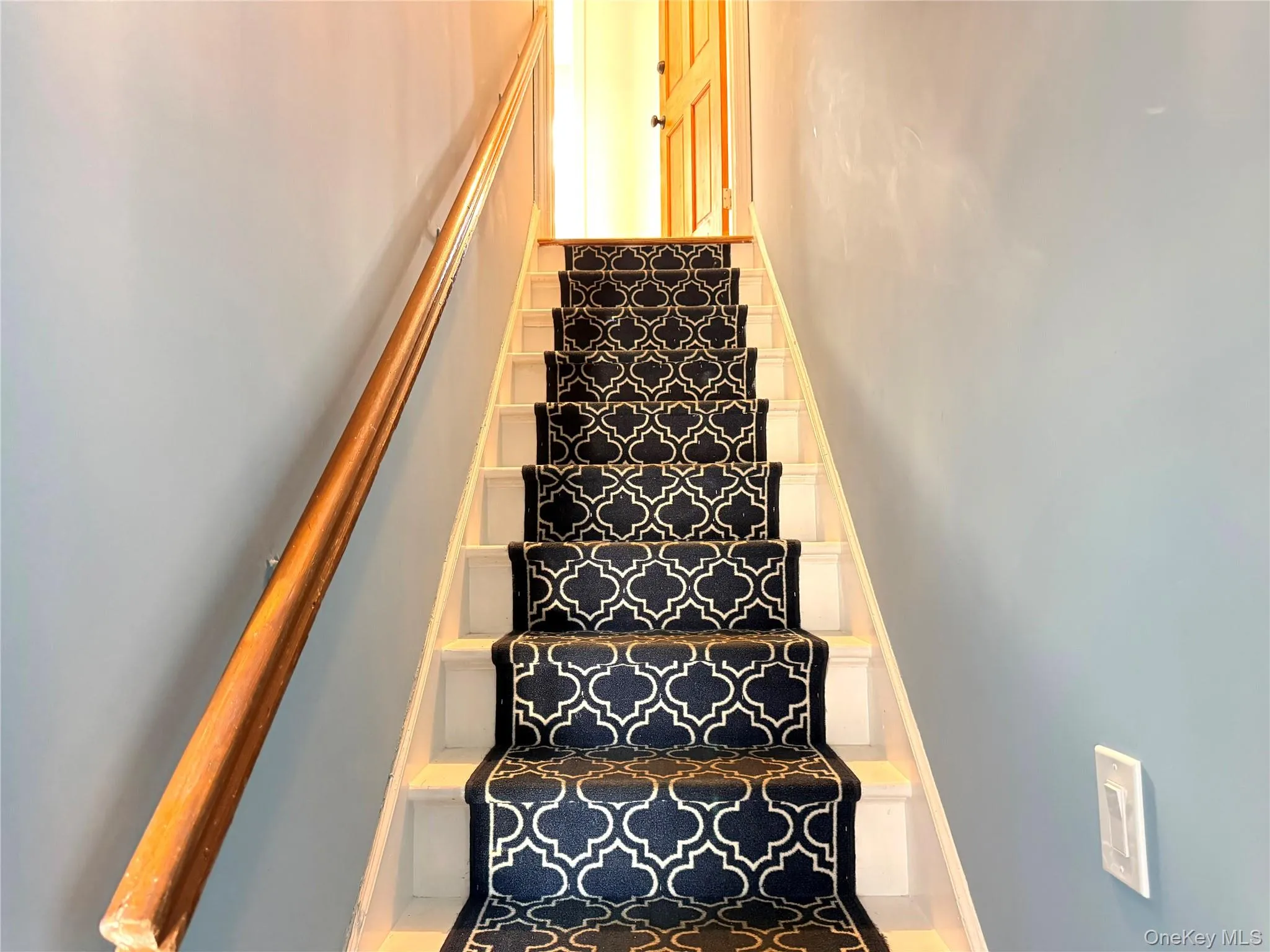 Staircase leading to the private second-floor apartment. Staircase leading to the private second-floor apartment.