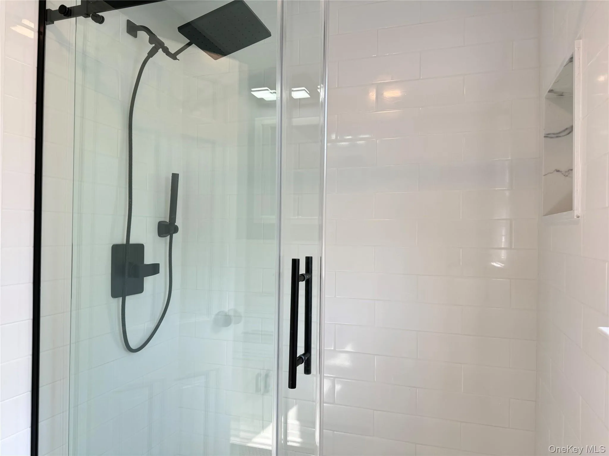 Contemporary shower showcasing modern fixtures and updated finishes. Contemporary shower showcasing modern fixtures and updated finishes.