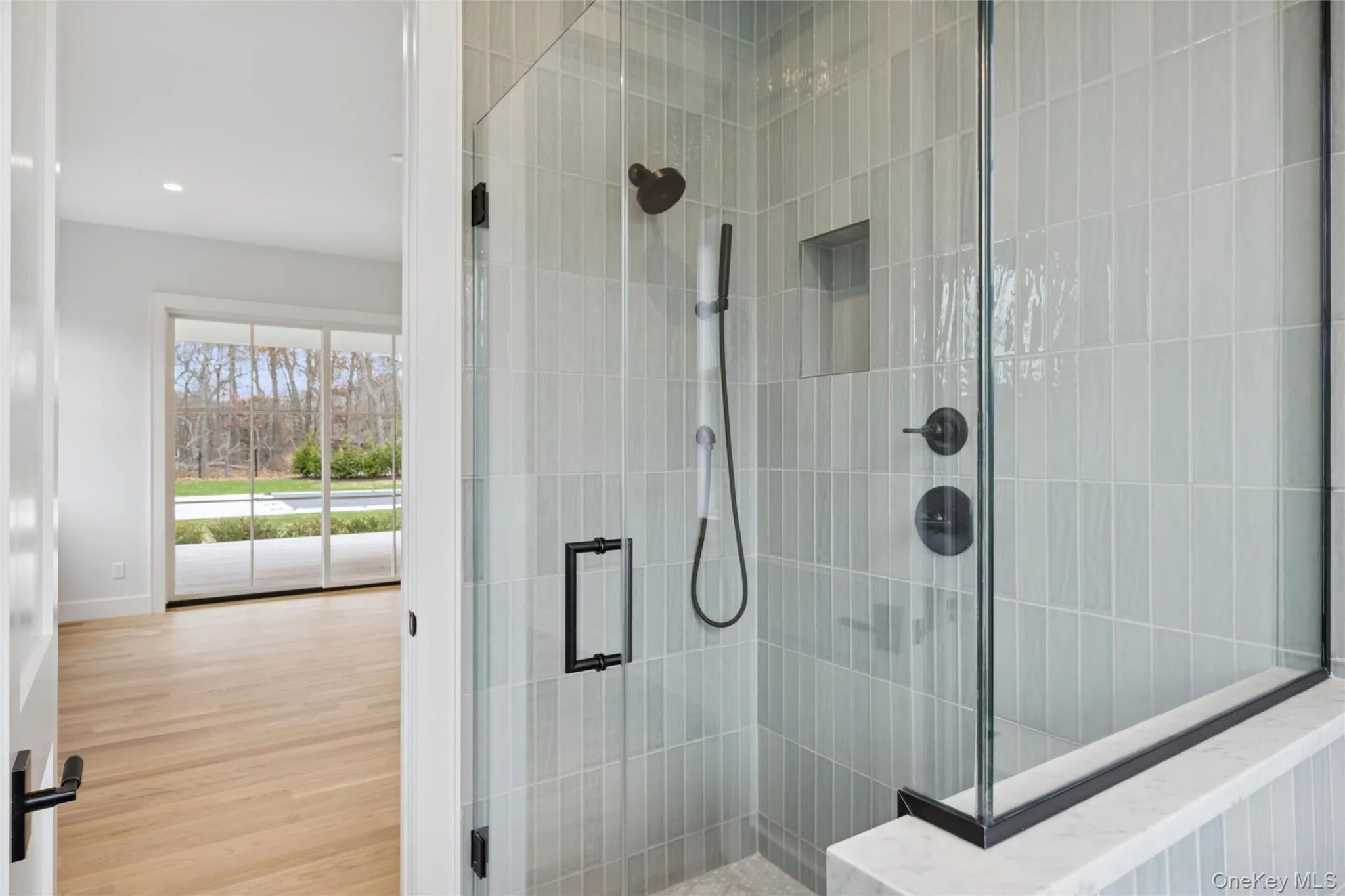 Full bathroom with a shower stall, wood finished floors, and recessed lighting Full bathroom with a shower stall, wood finished floors, and recessed lighting