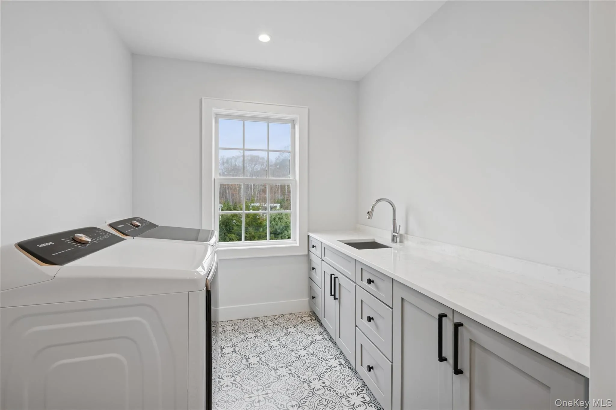 upstairs laundry area featuring cabinet space, independent washer and dryer, and recessed lighting upstairs laundry area featuring cabinet space, independent washer and dryer, and recessed lighting