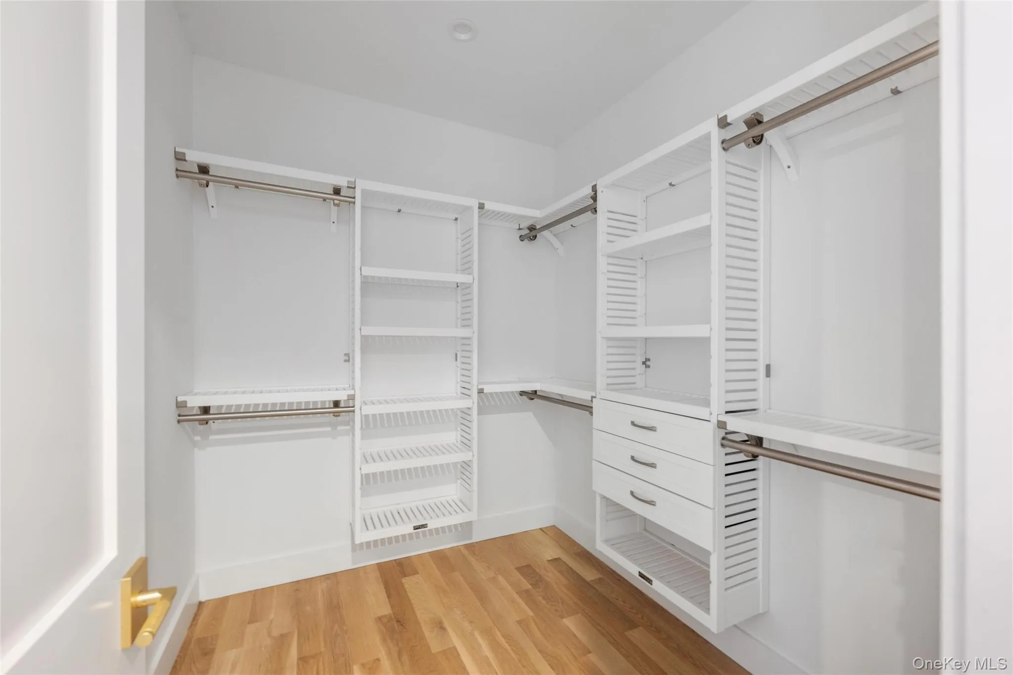 Spacious closet featuring light wood-type flooring Spacious closet featuring light wood-type flooring