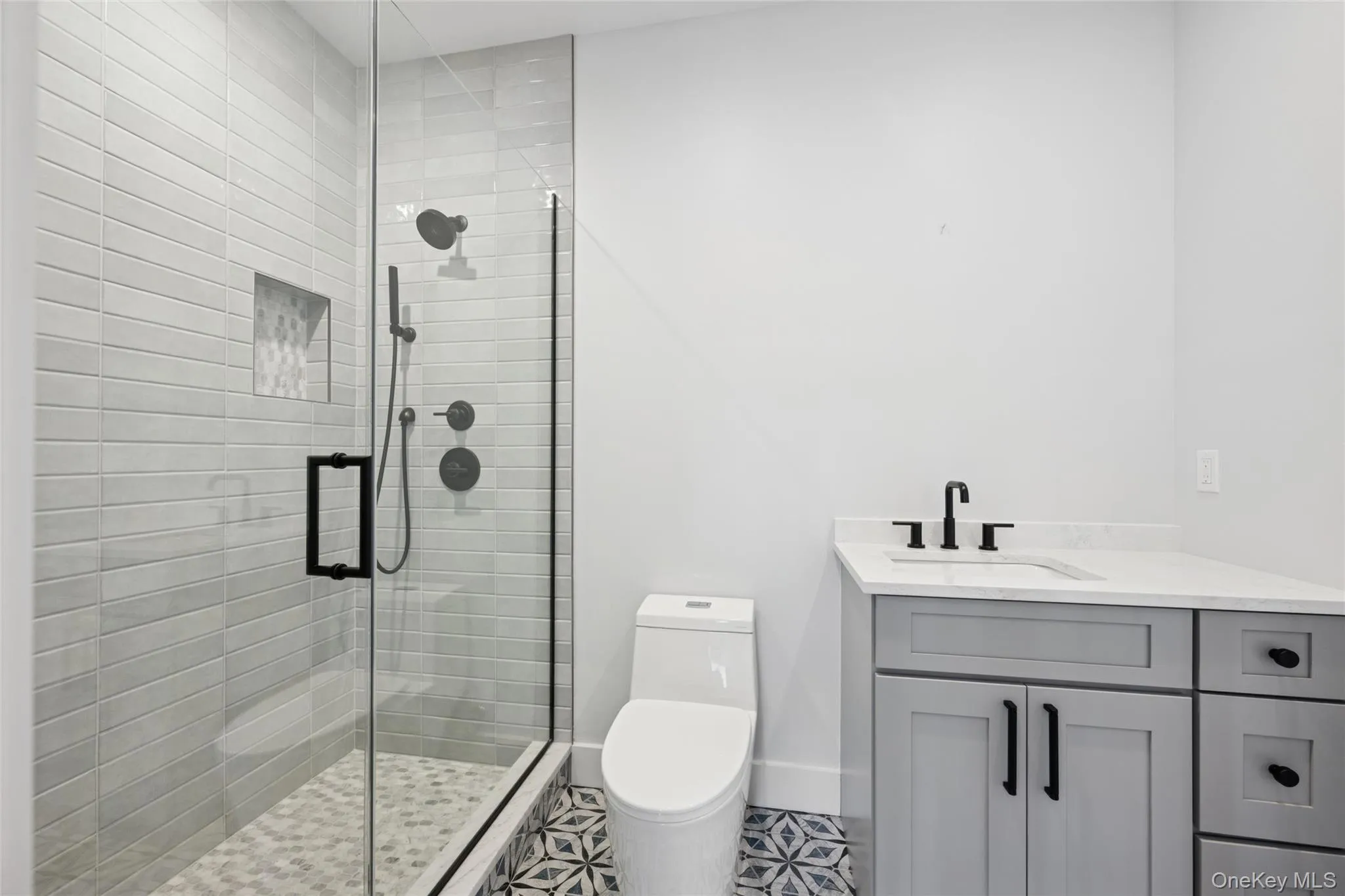 Bathroom featuring vanity and a shower stall Bathroom featuring vanity and a shower stall