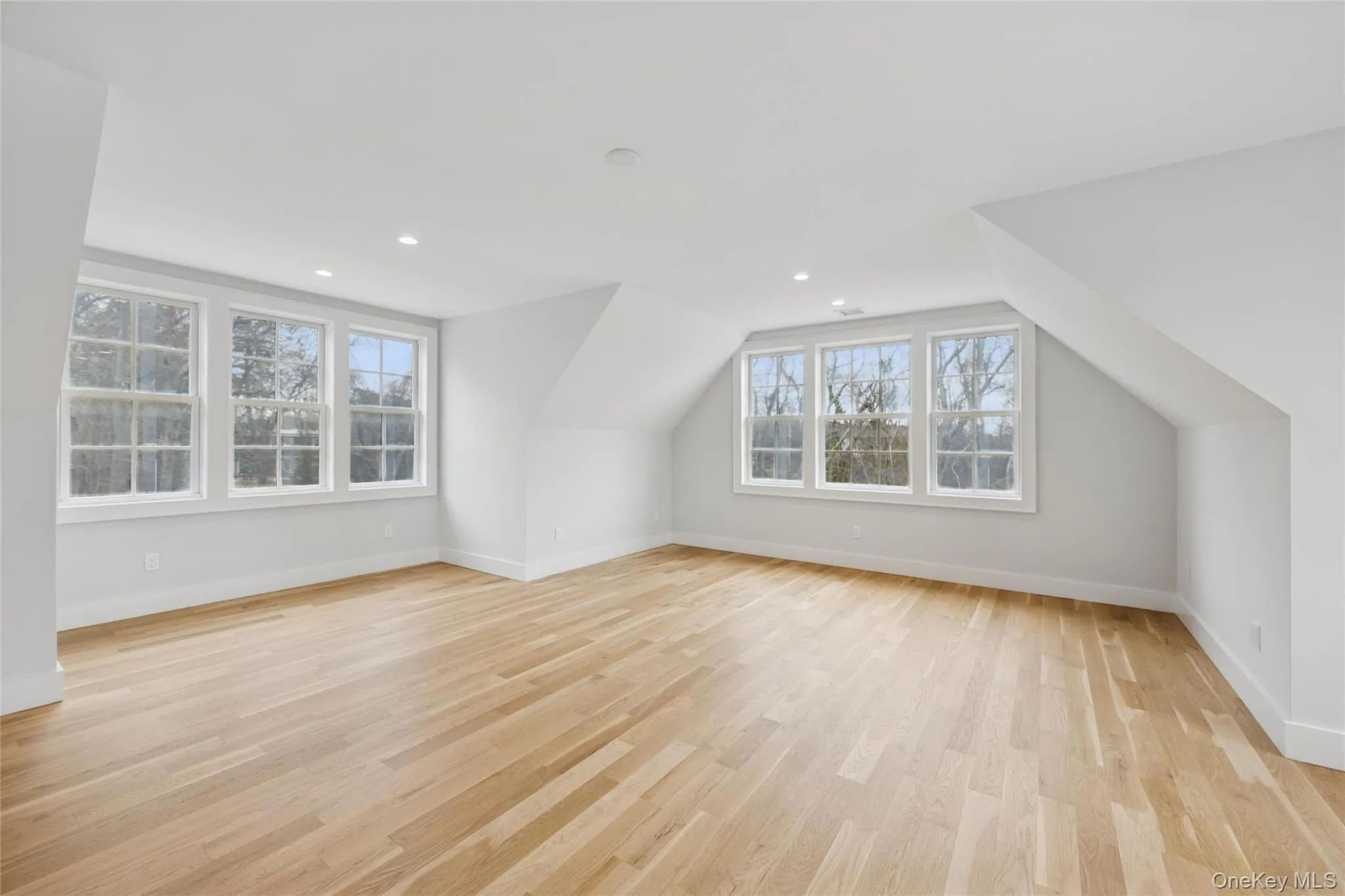 Bonus room with light wood-style floors, vaulted ceiling, and recessed lighting Bonus room with light wood-style floors, vaulted ceiling, and recessed lighting