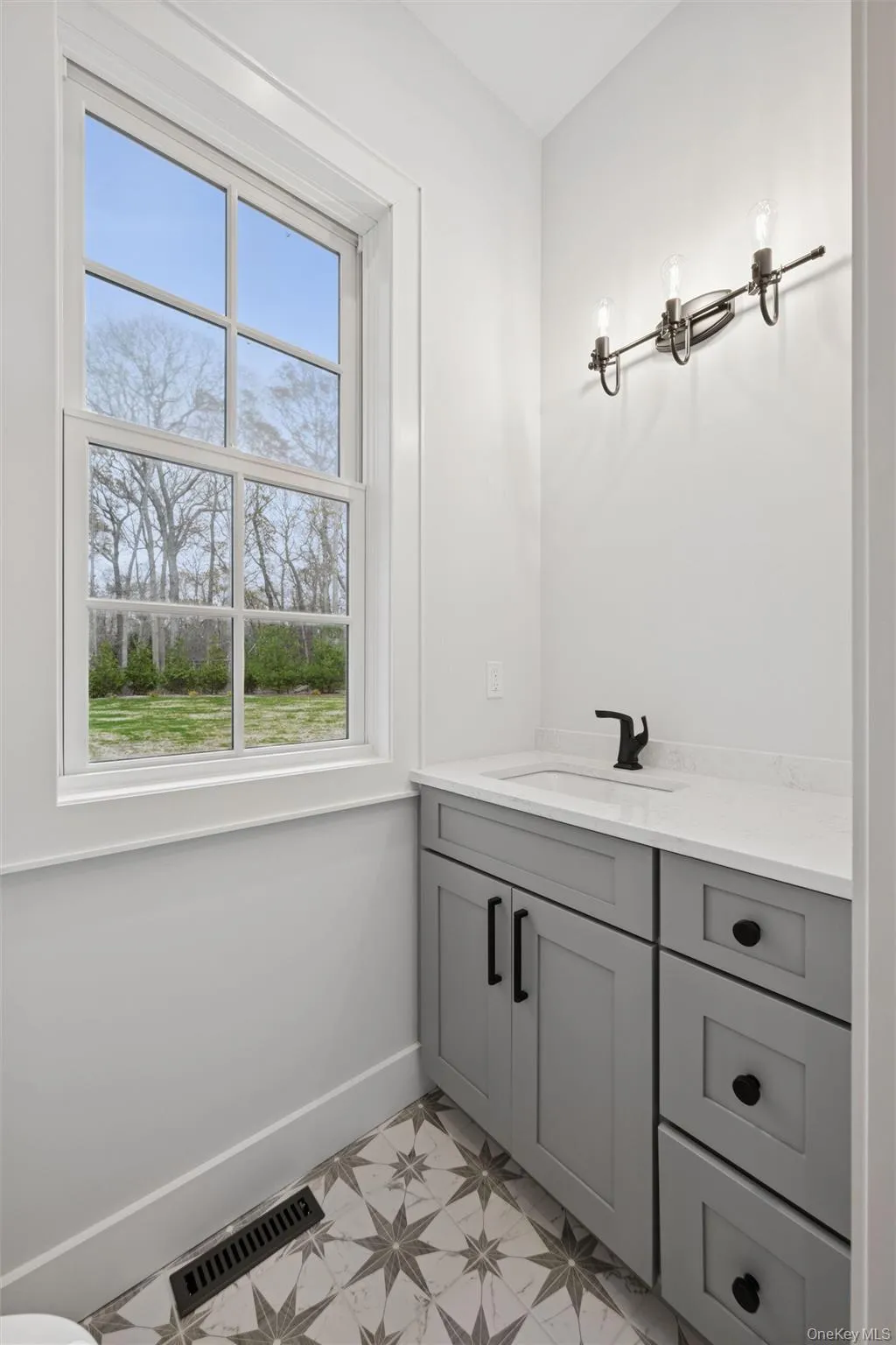 Half bath in mudroom with vanity and light flooring Half bath in mudroom with vanity and light flooring