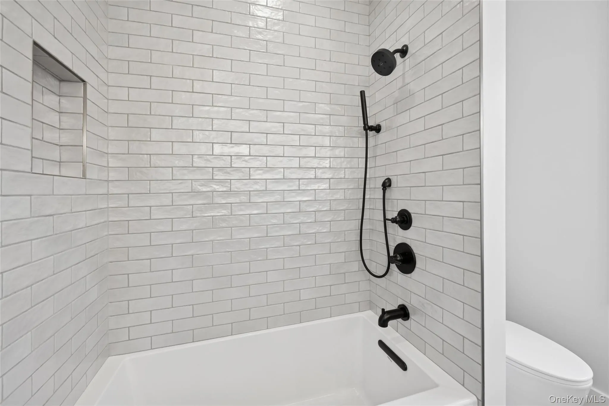 Bathroom with tub / shower combination and toilet Bathroom with tub / shower combination and toilet