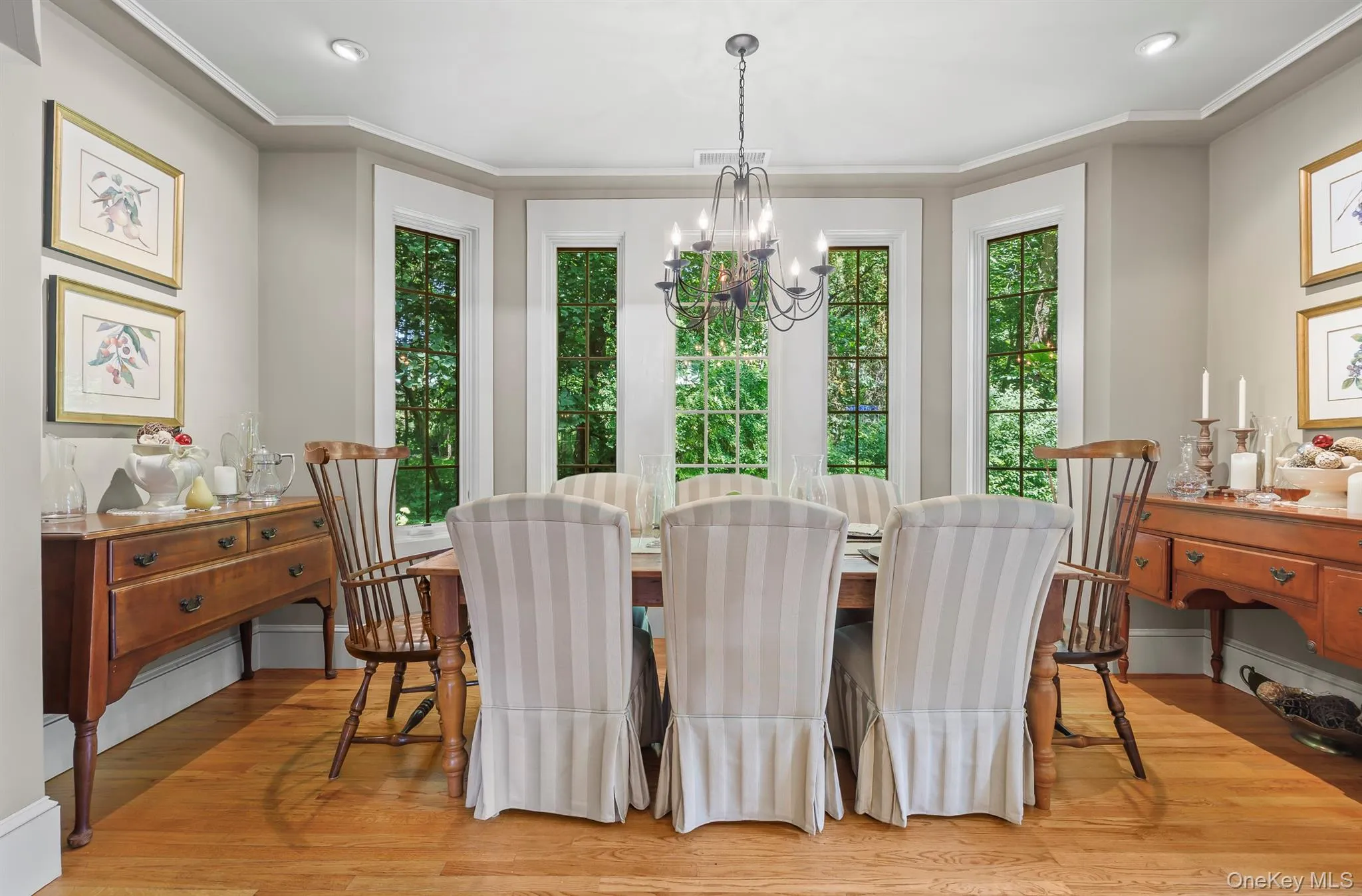 A charming formal dining area with a wall of windows is part of the open floor plan A charming formal dining area with a wall of windows is part of the open floor plan