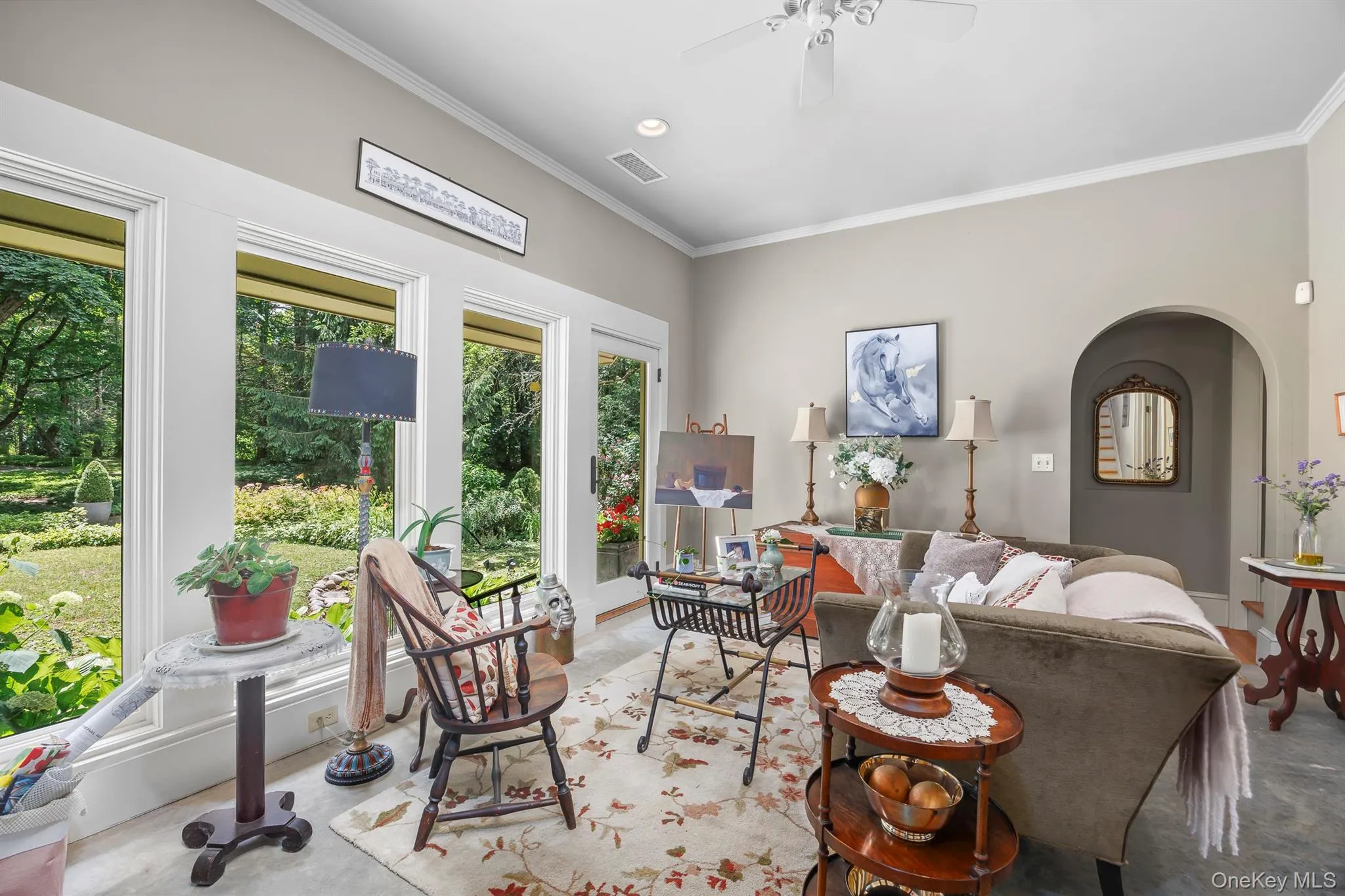 A wonderful sun room/den with a wall of windows overlooks lovely gardens A wonderful sun room/den with a wall of windows overlooks lovely gardens